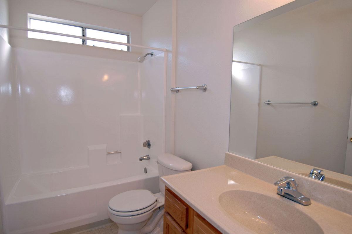a white tub sitting next to a sink
