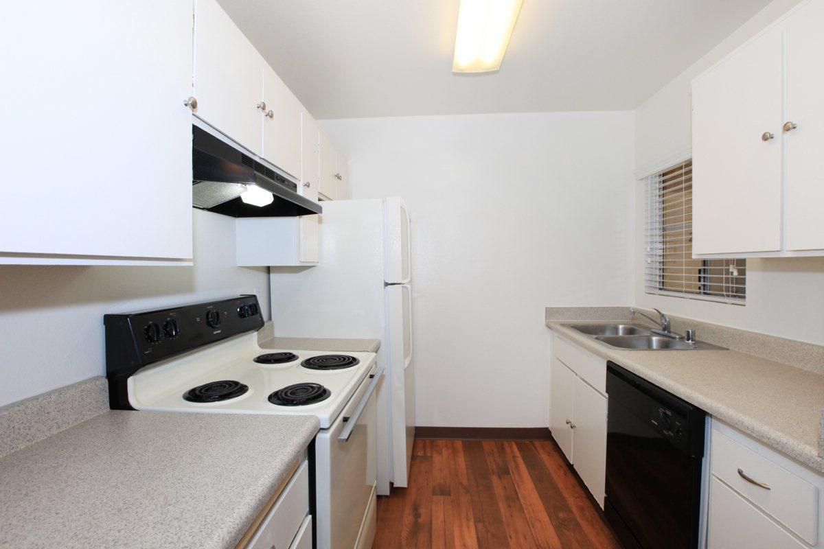 a white stove top oven sitting inside of a kitchen