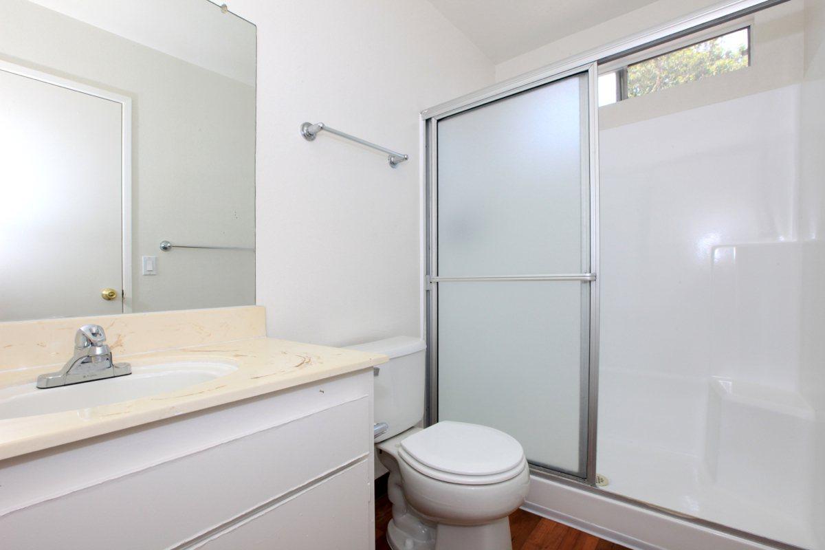 a white tub sitting next to a shower