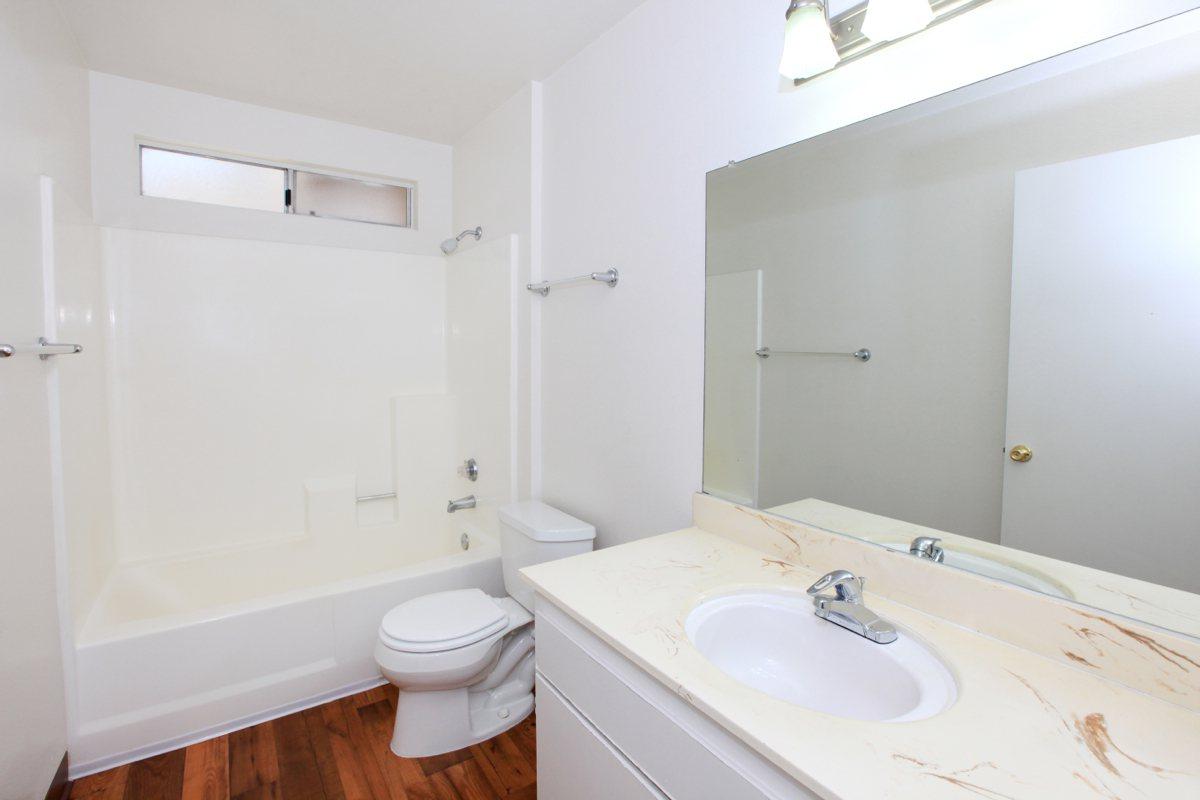 a large white tub sitting next to a sink