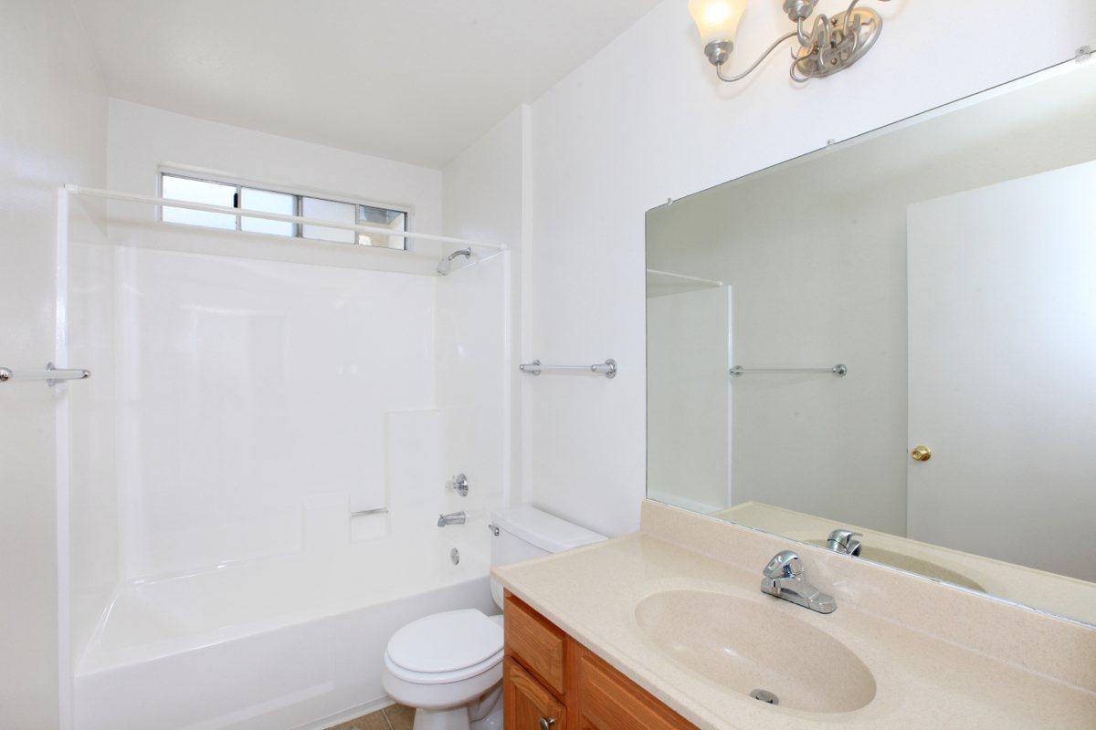 a white tub sitting next to a sink