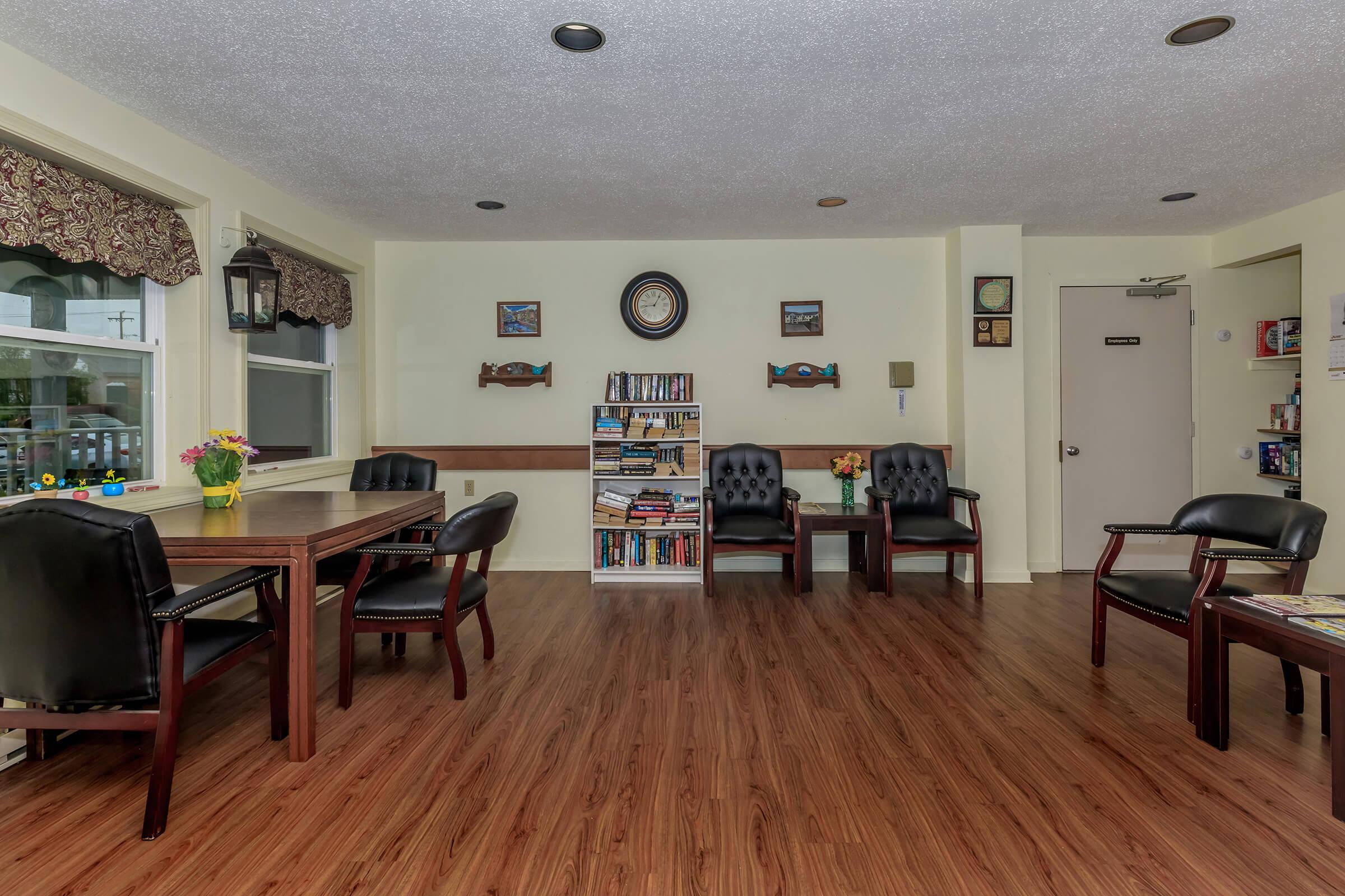 a living room filled with furniture on top of a hard wood floor