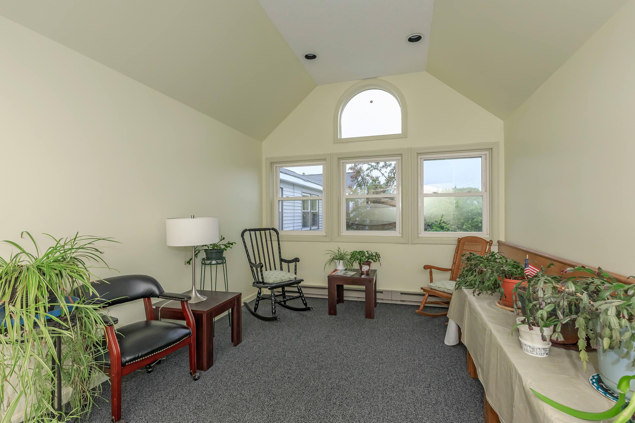 a living room filled with furniture and a large window