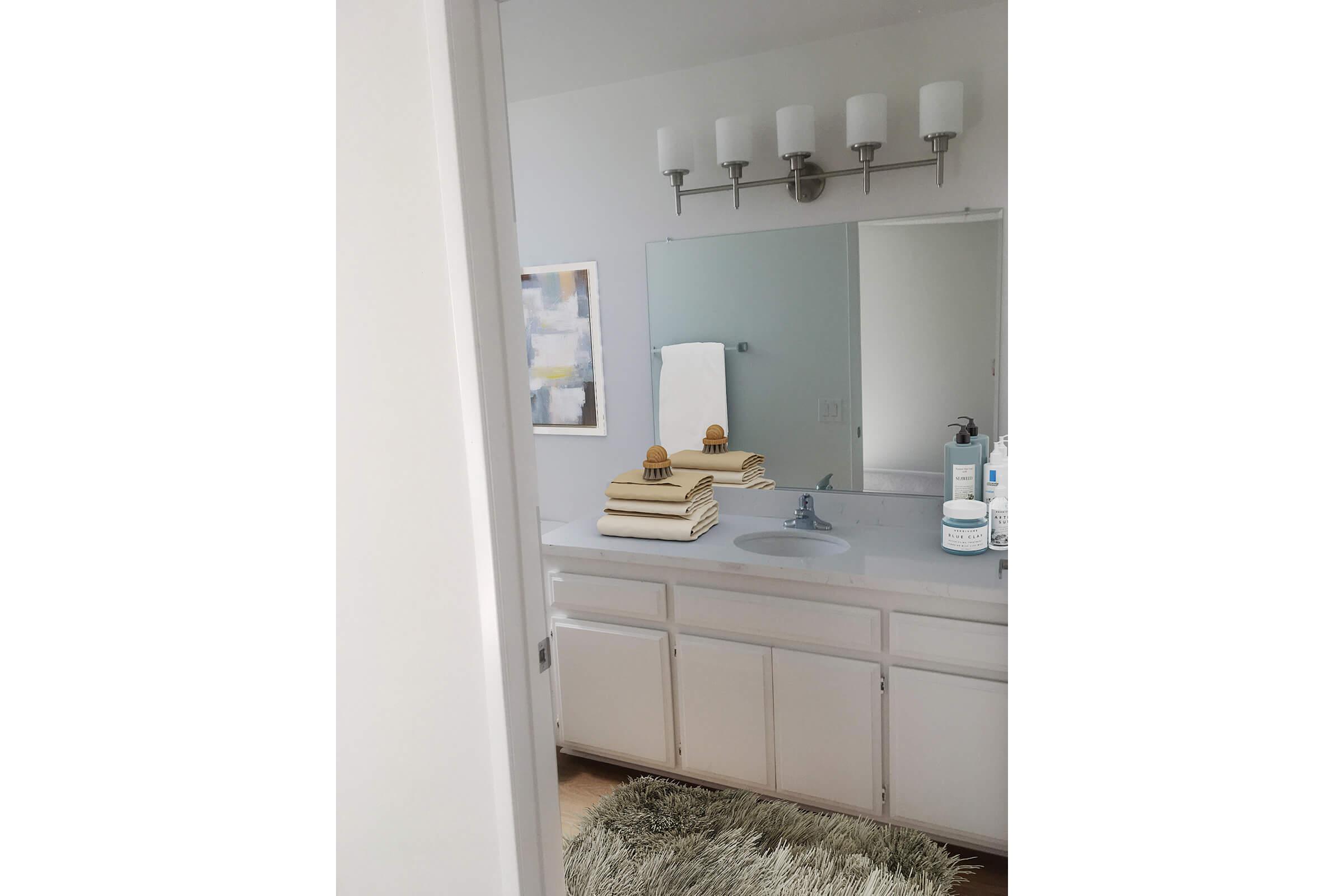 a kitchen with a sink and a mirror