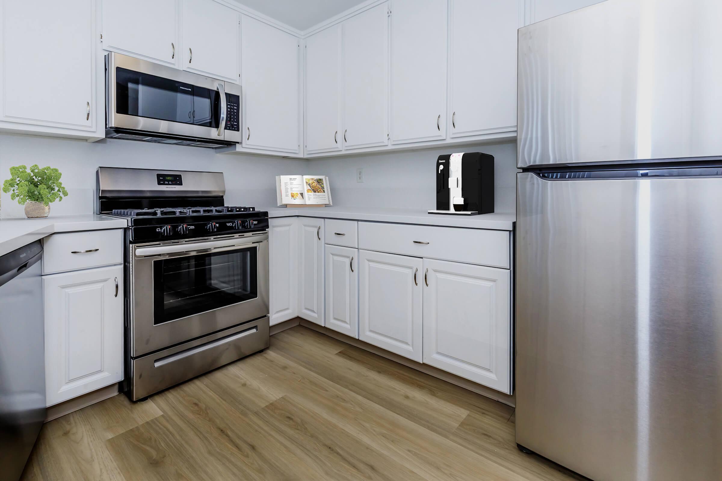 a stove top oven sitting inside of a kitchen