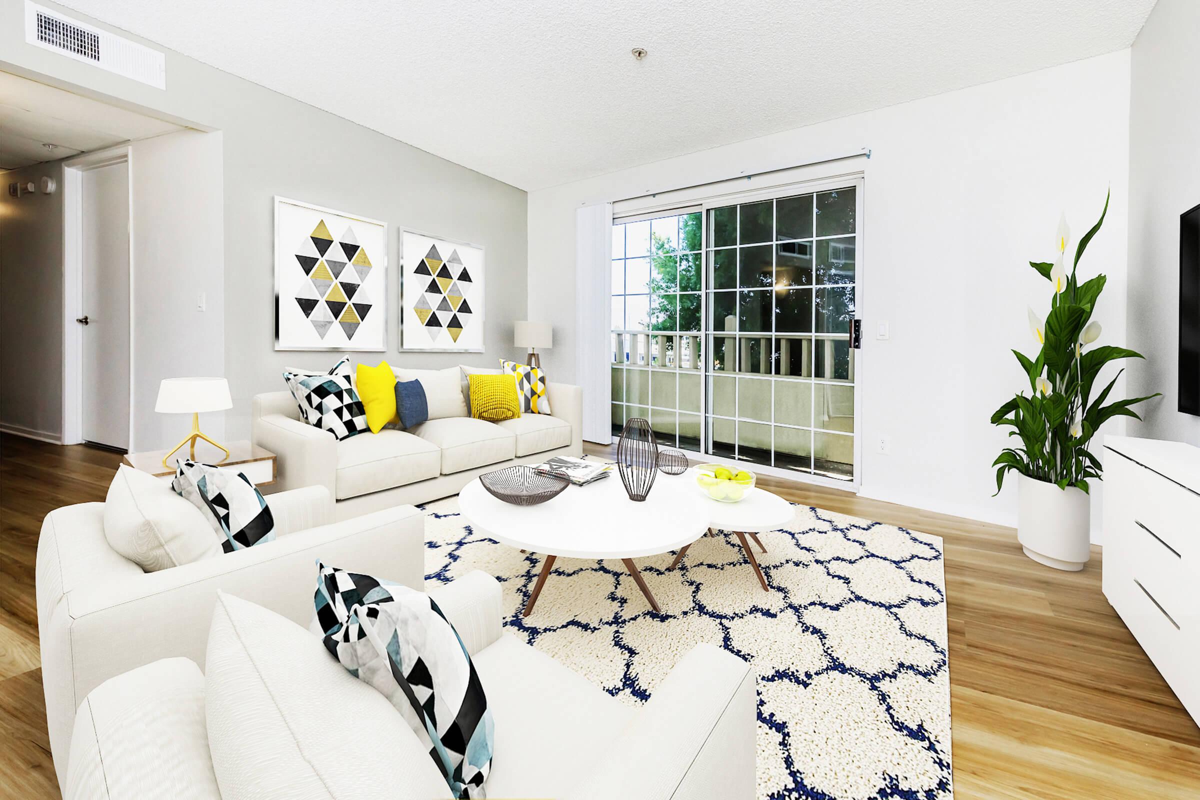 a living room filled with furniture and a large window