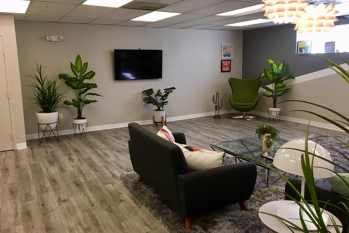 a living room filled with furniture and a flat screen tv