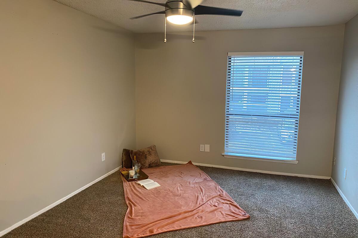 a bedroom with a bed in a room