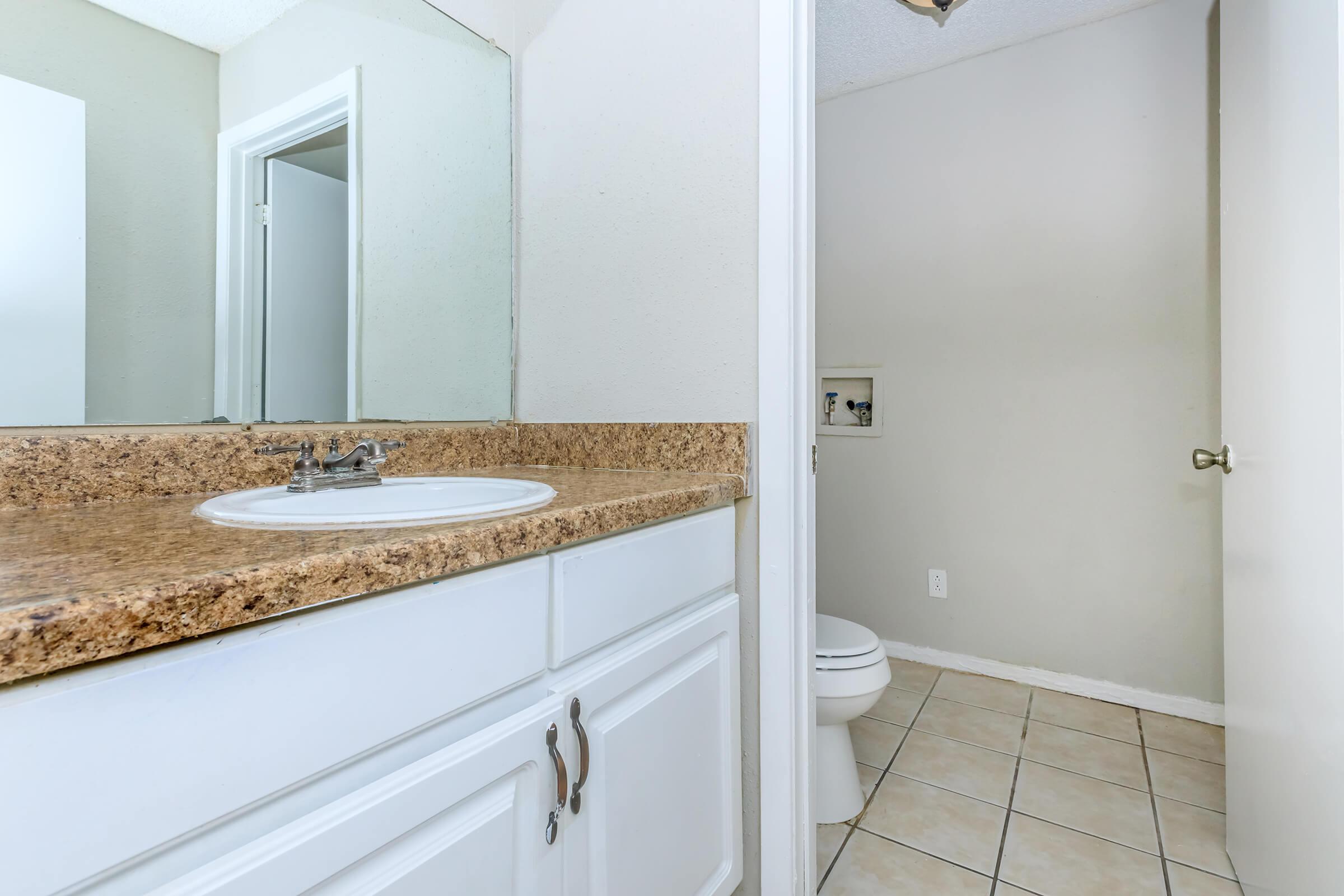 a room with a sink and a mirror