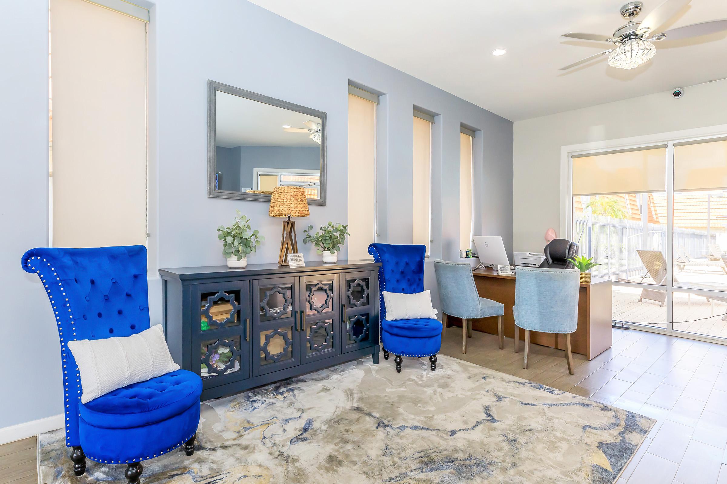 a living room filled with furniture and a blue sky