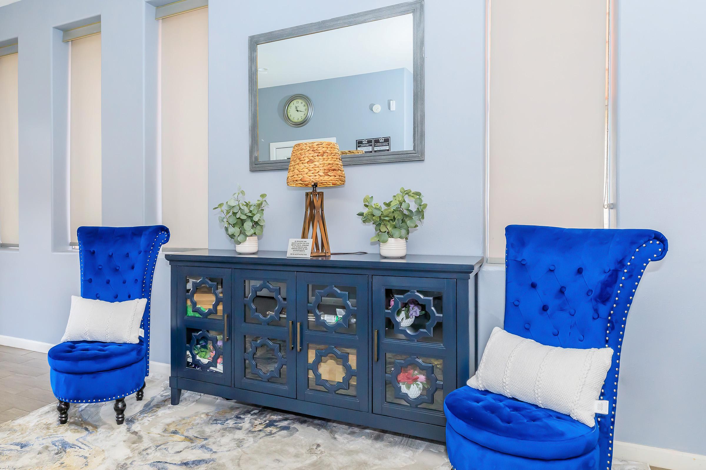 a bedroom with a blue vase on a table