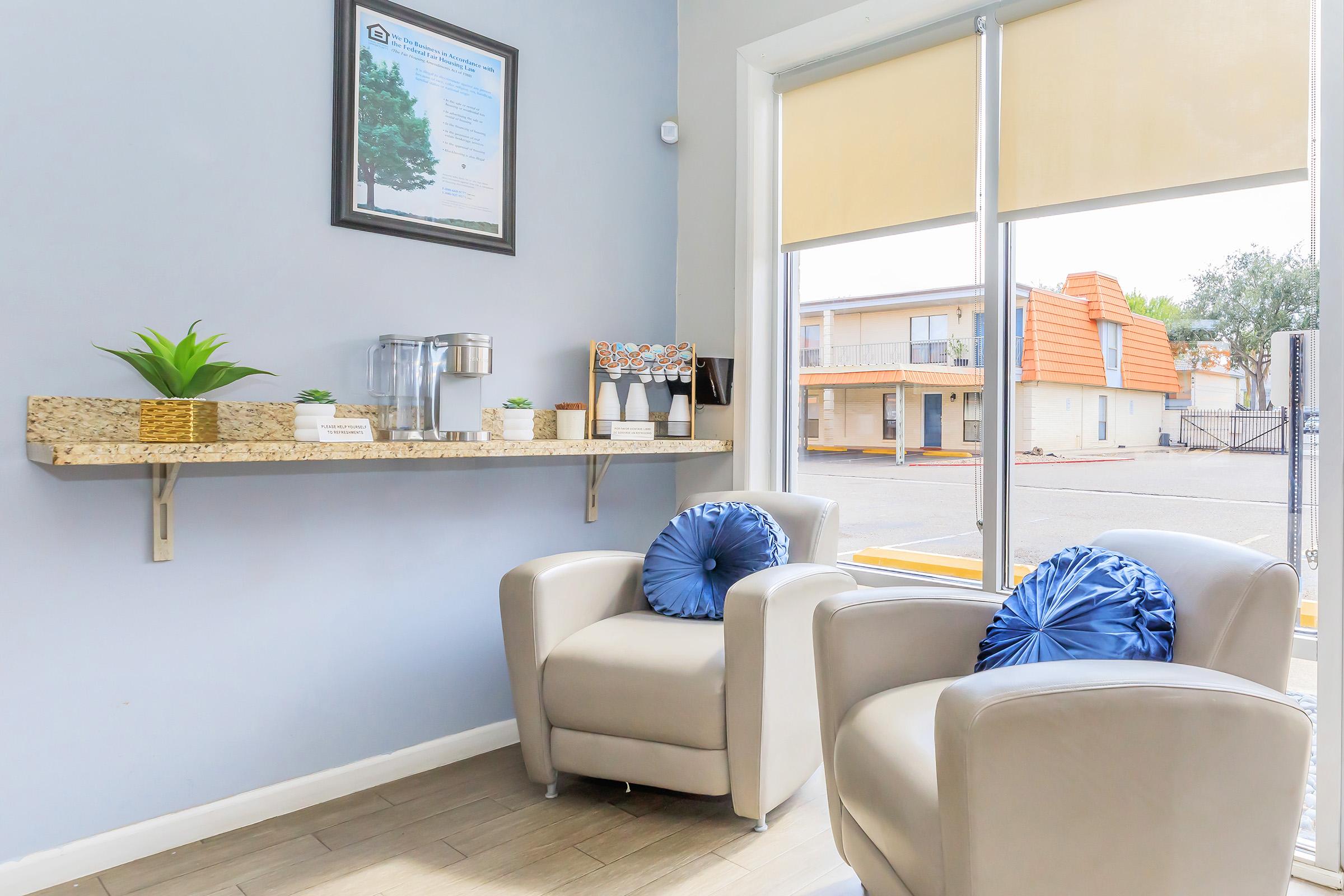 a living room filled with furniture and a large window