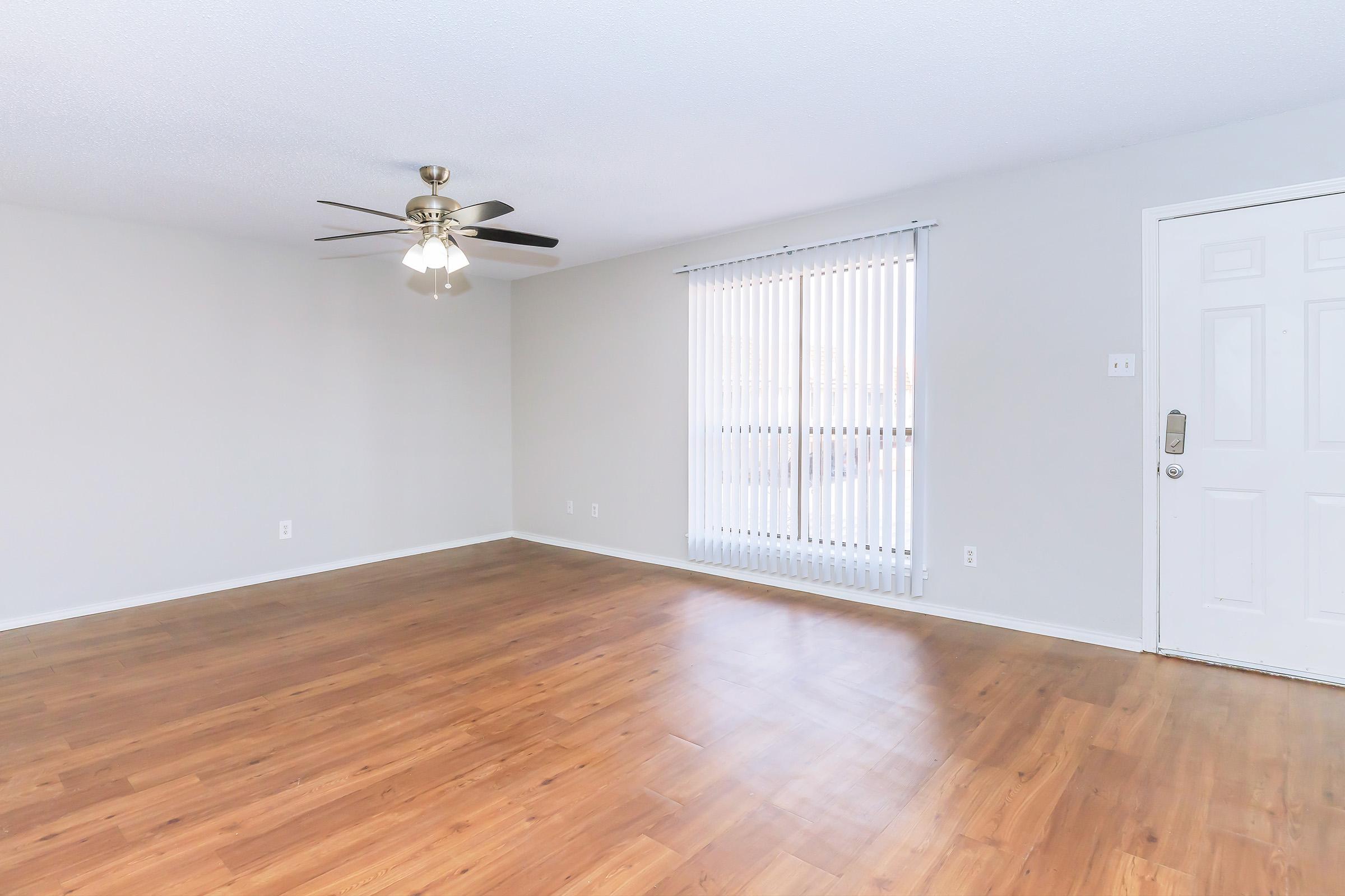 a large empty room with a wooden floor