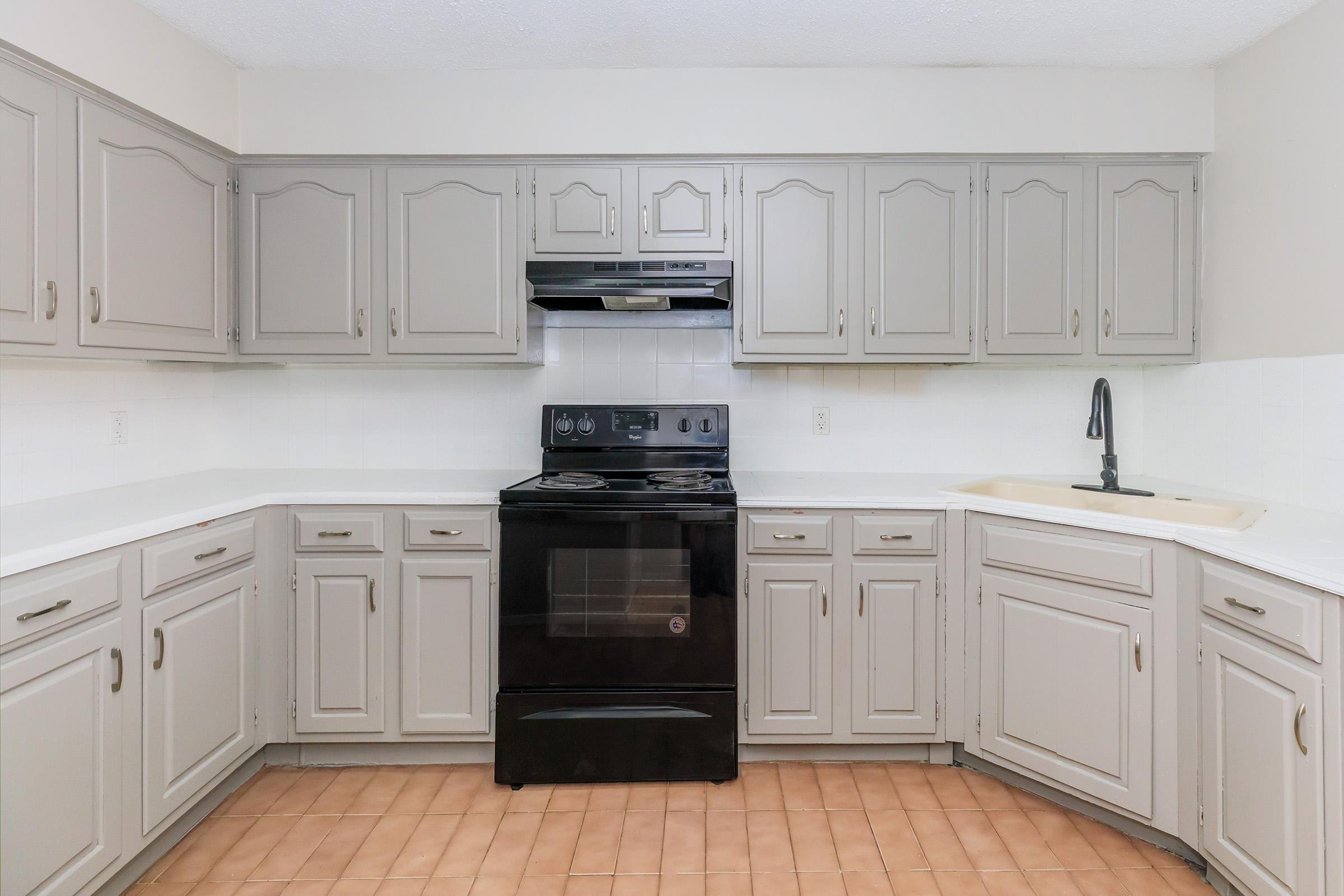 a kitchen with a stove and a refrigerator