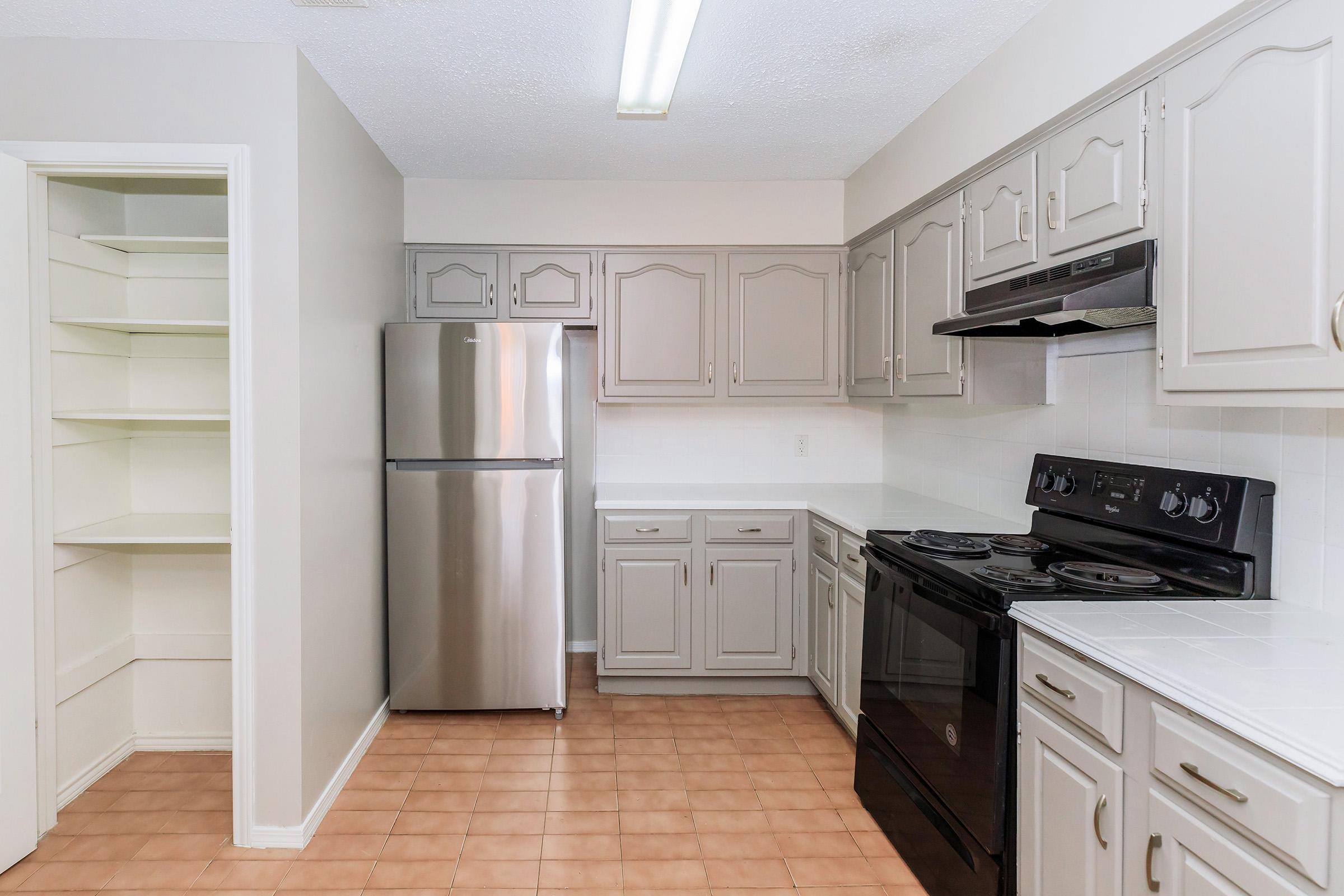 a kitchen with a stove and a refrigerator