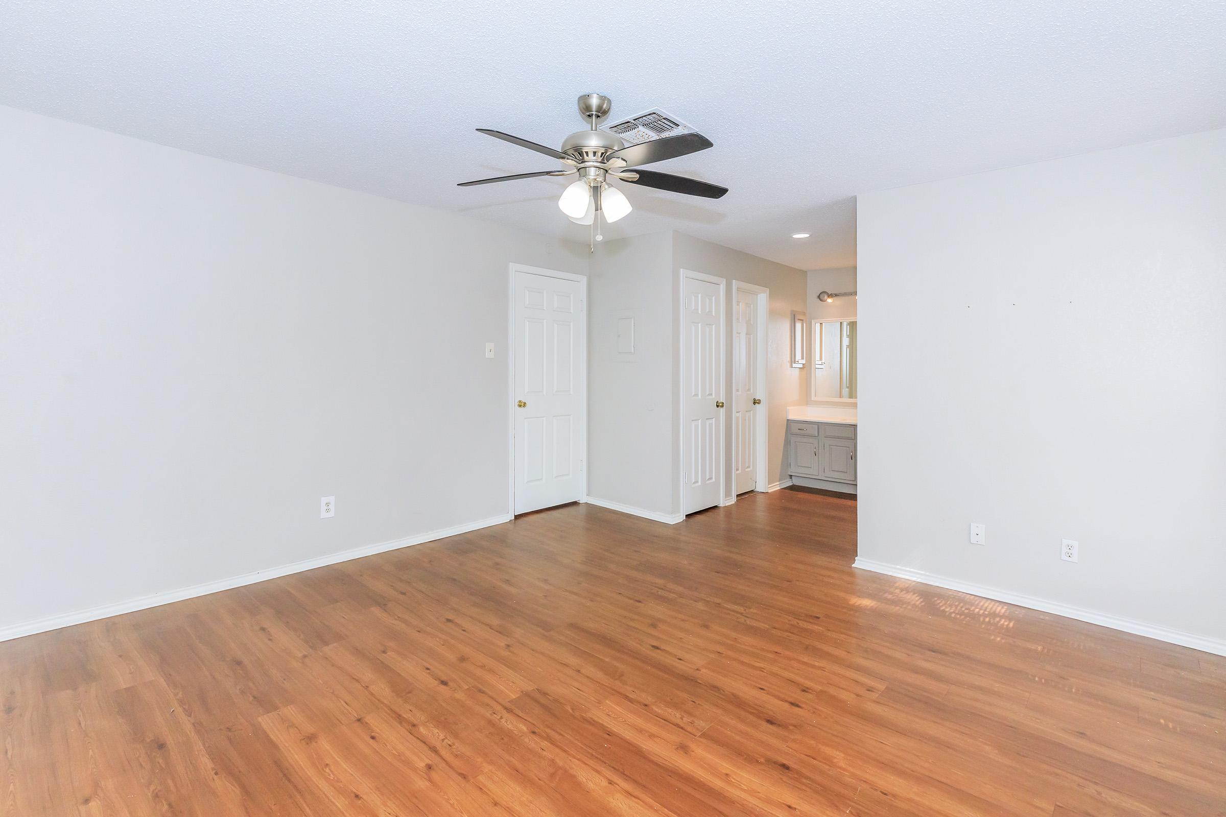 a large empty room with a wooden floor