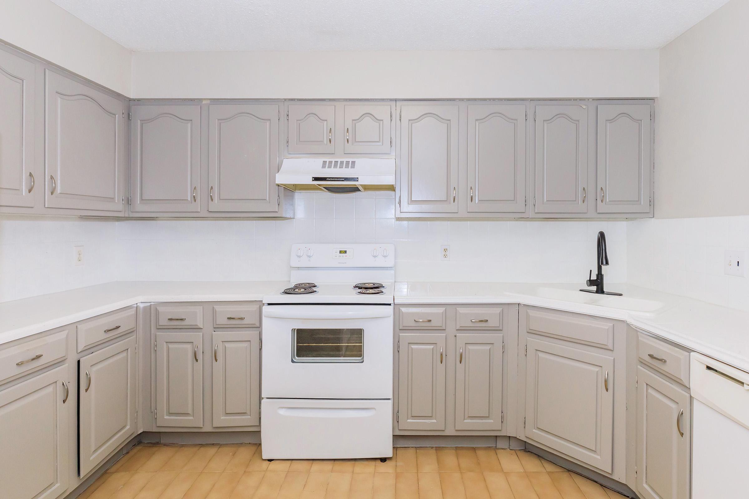 a kitchen with a stove and a refrigerator