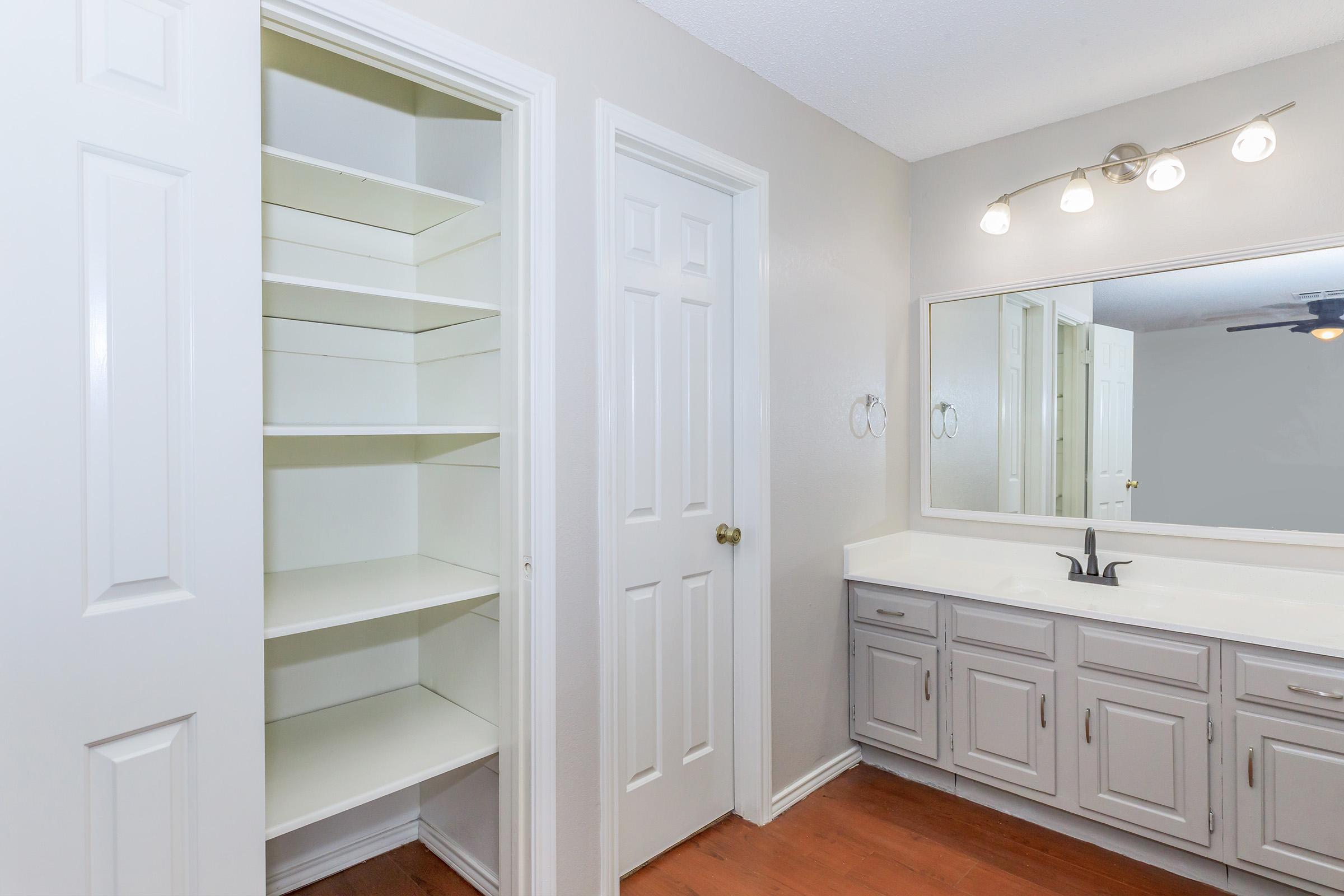 a kitchen with a sink and a mirror