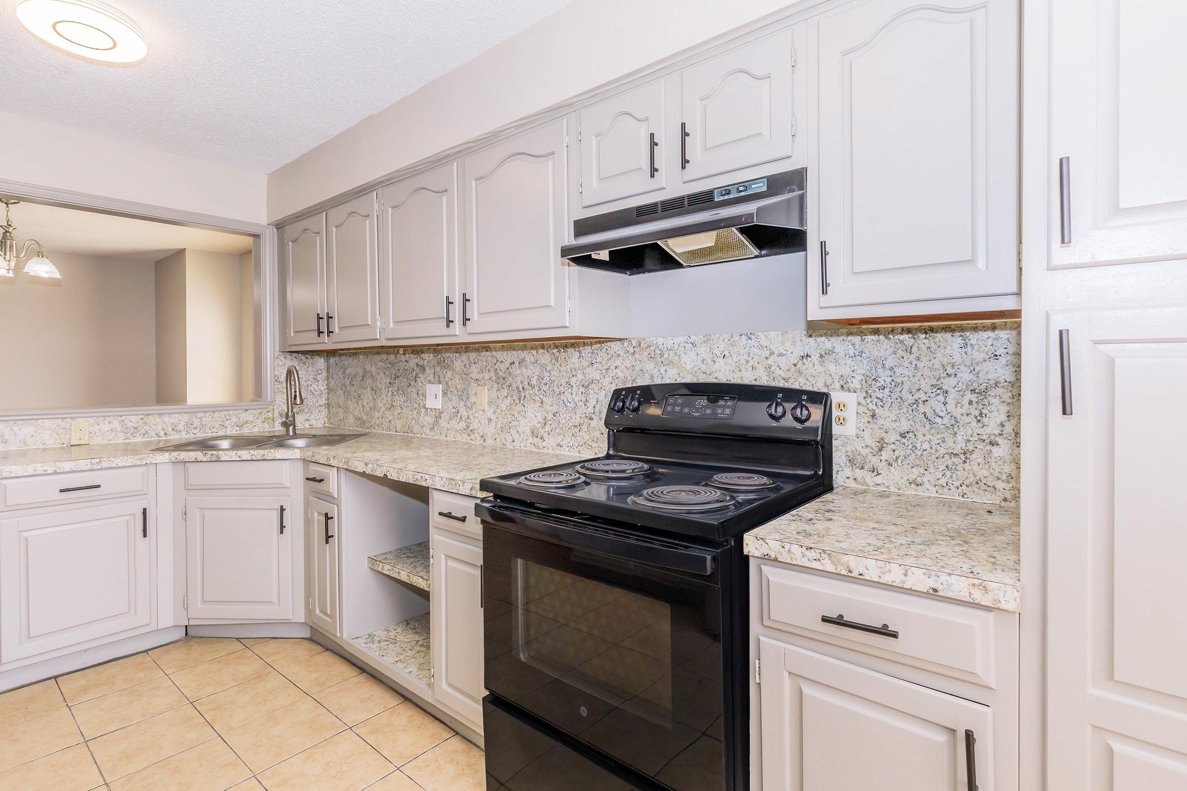 a kitchen with a stove top oven