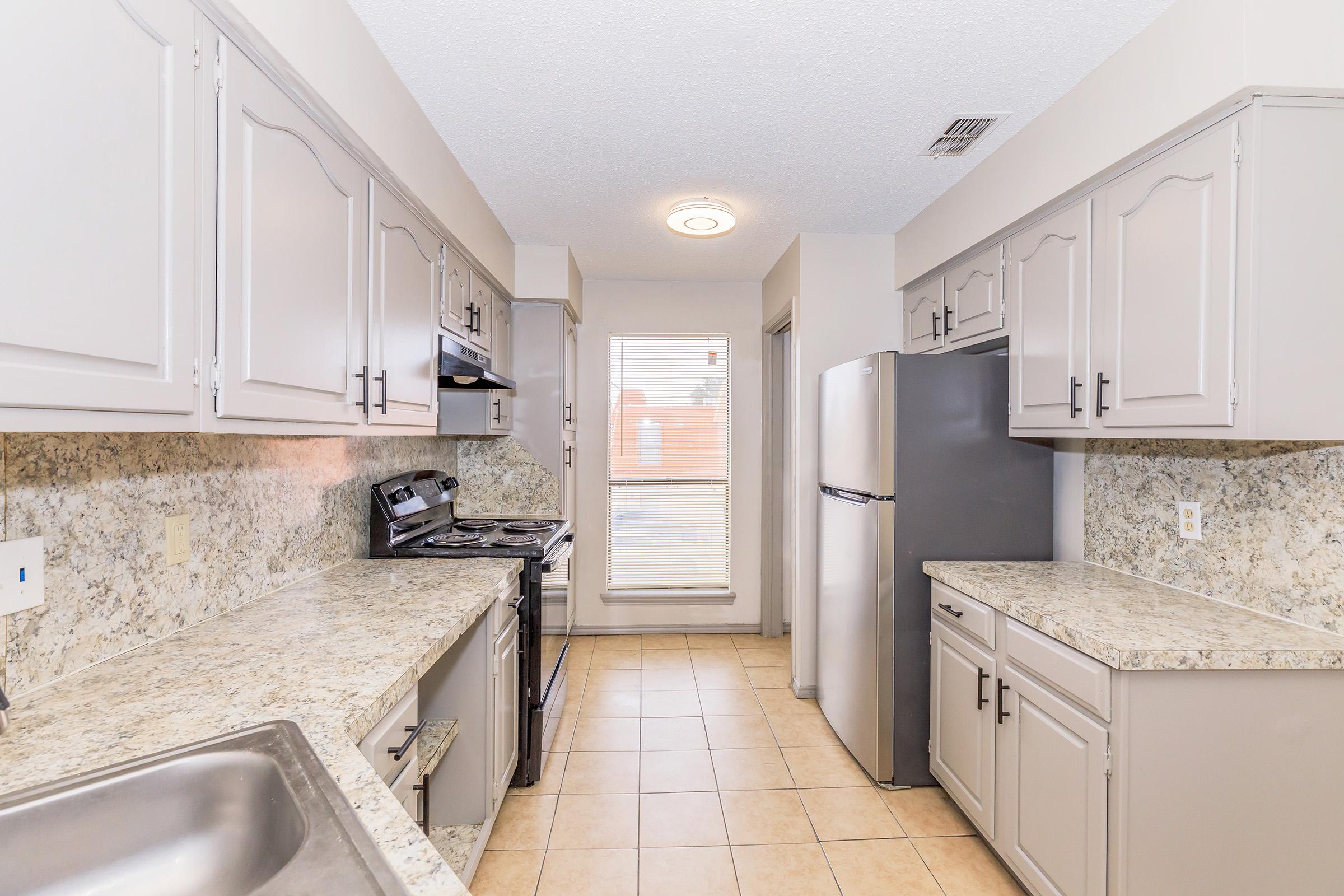 a kitchen with a sink and a window