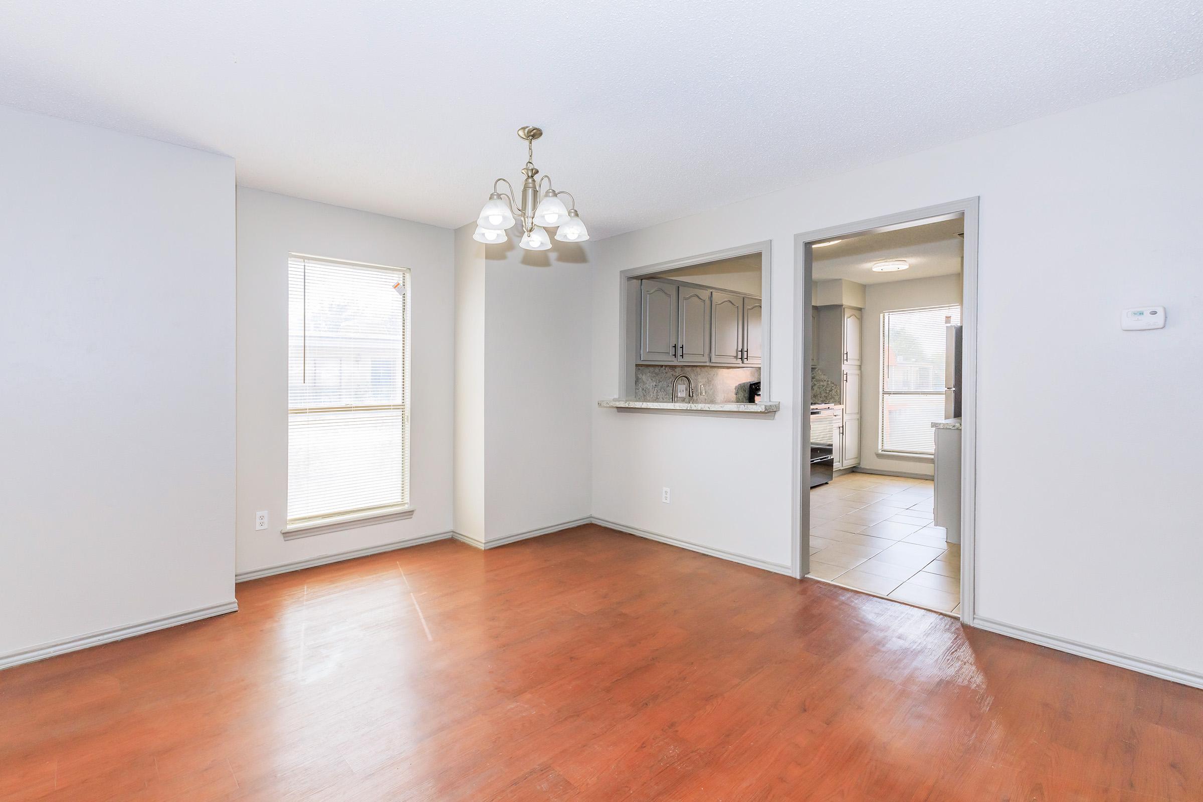 a kitchen with a hard wood floor