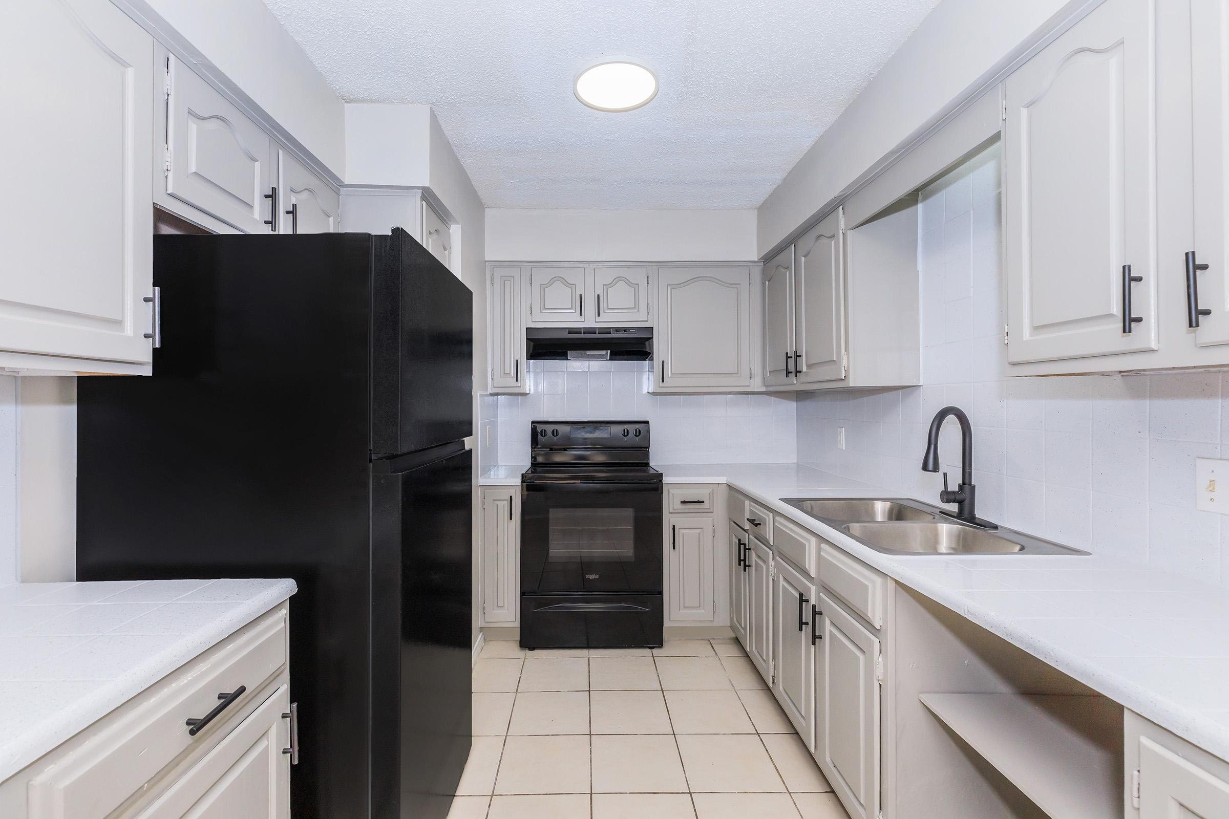 a kitchen with a stove sink and refrigerator