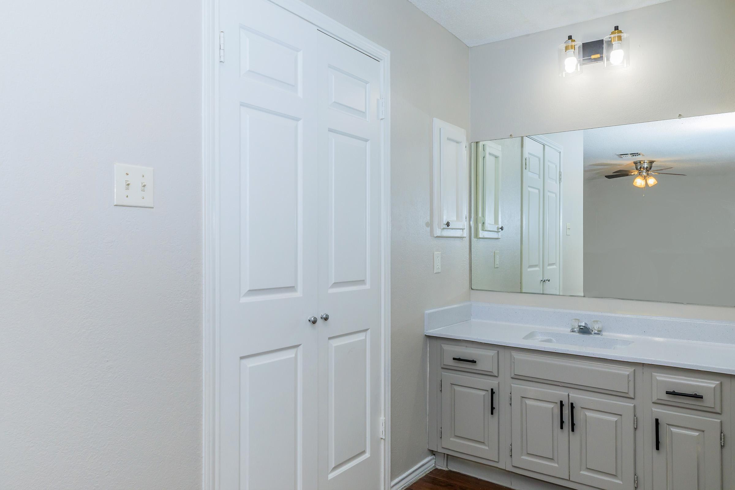 a kitchen with a sink and a mirror