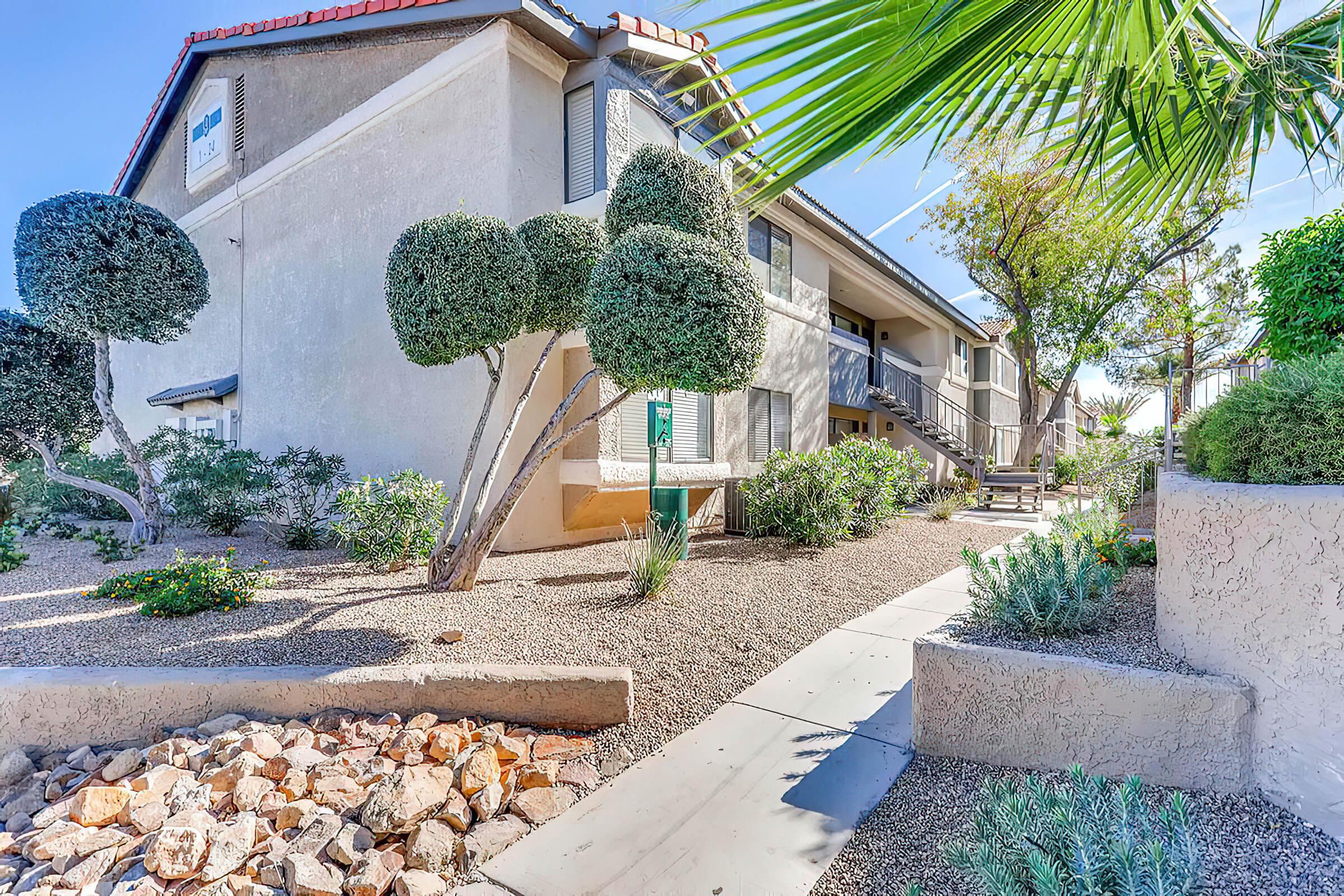 a stone building with palm trees in front of a house