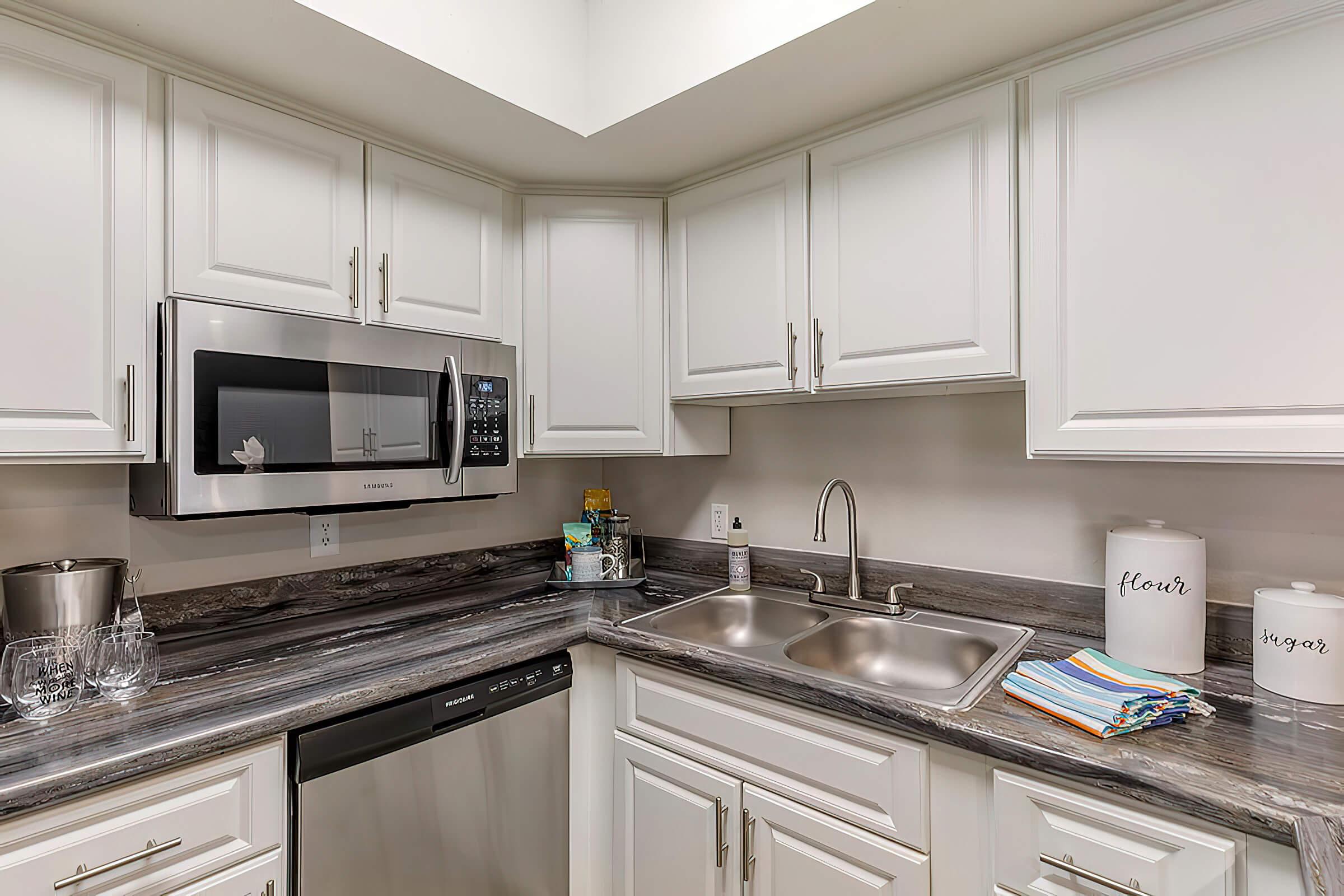 a kitchen with a sink and a microwave