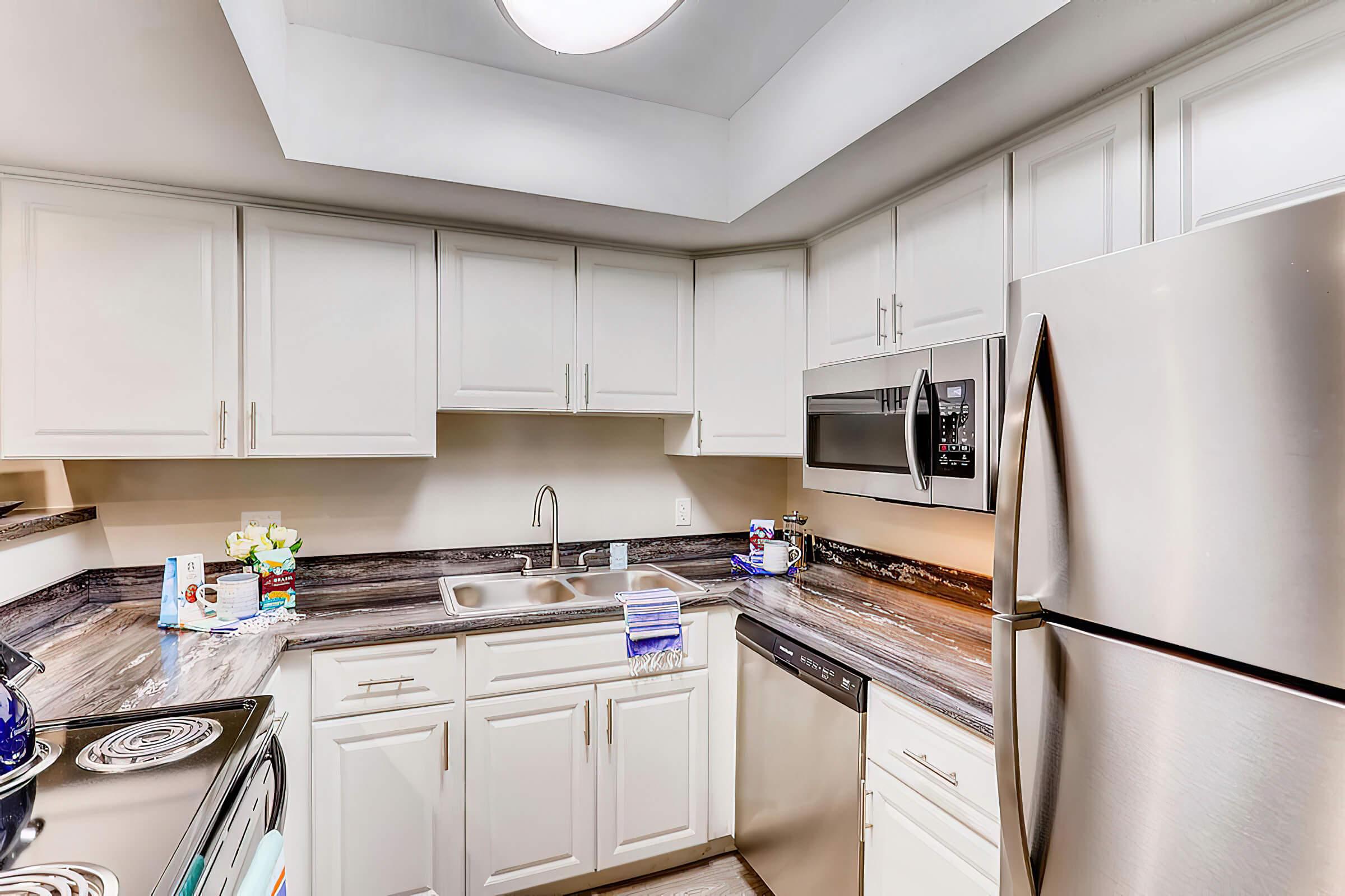 a kitchen with a stove sink and refrigerator