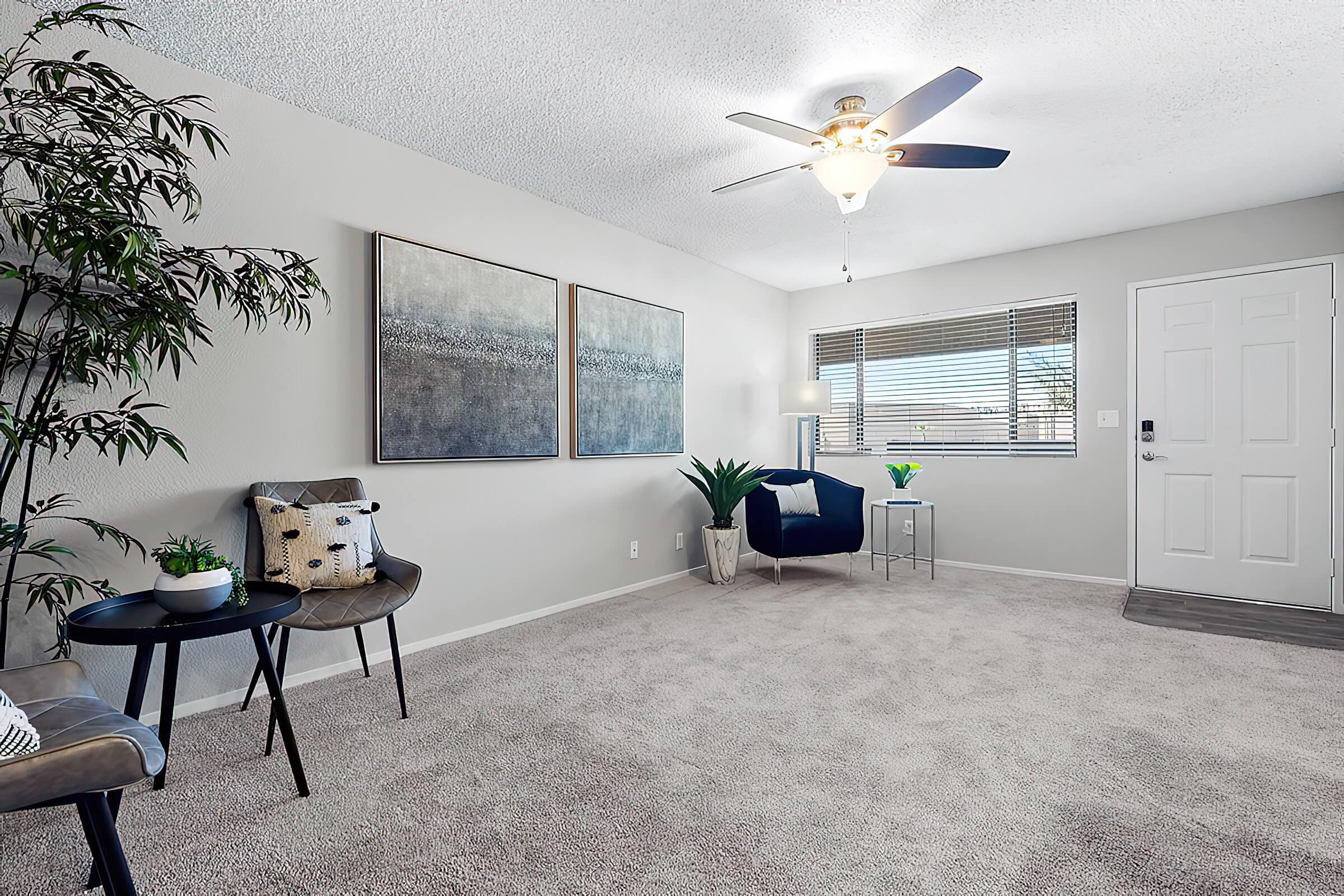 a living room filled with furniture and a large window