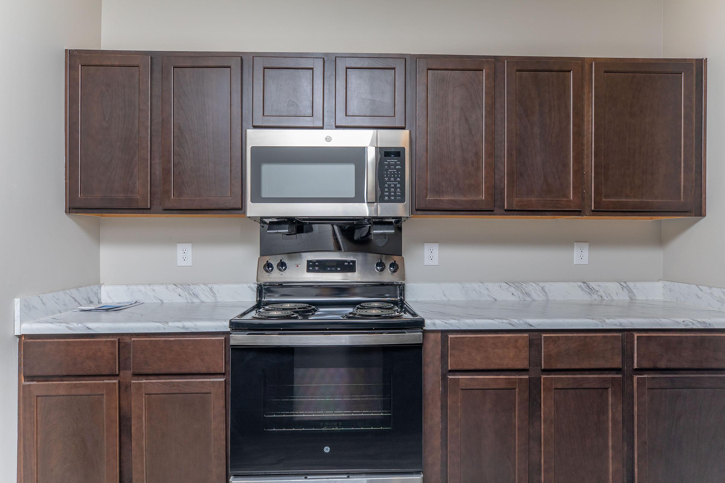 a stove top oven sitting inside of a kitchen