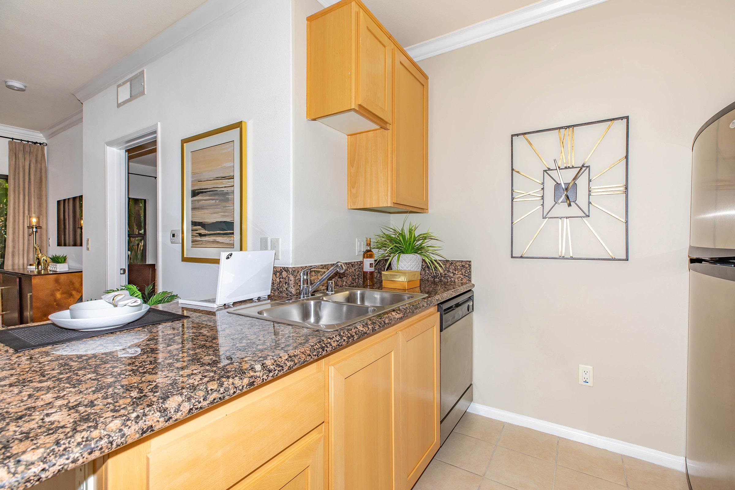 a kitchen with a sink and a mirror