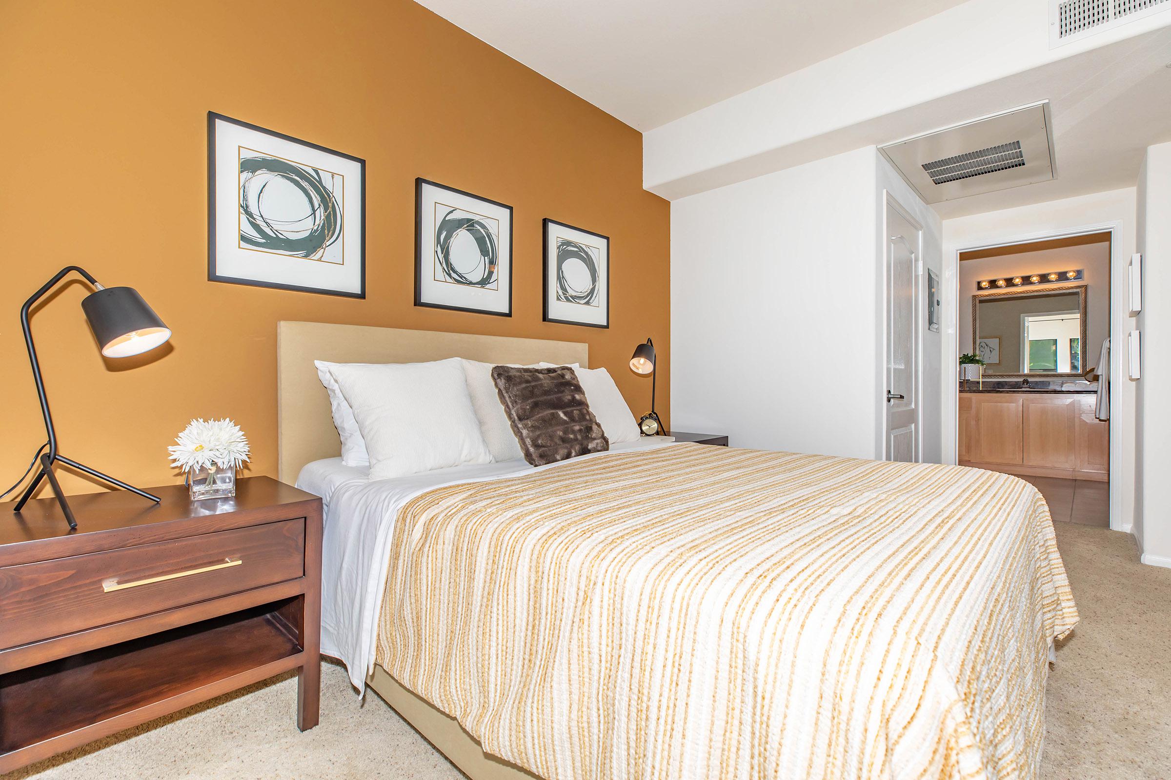 a bedroom with a bed in a room