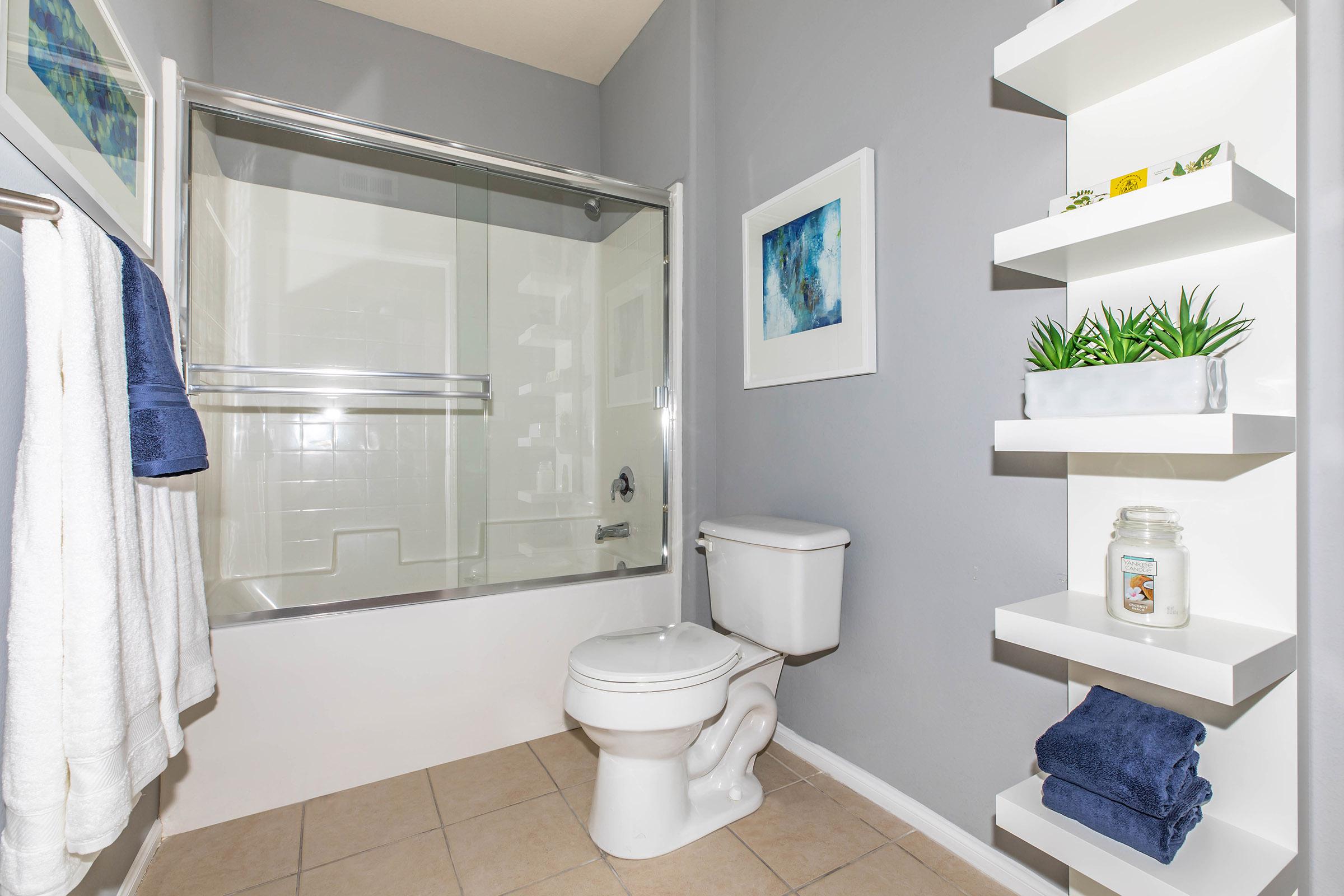 a furnished bathroom with white towels