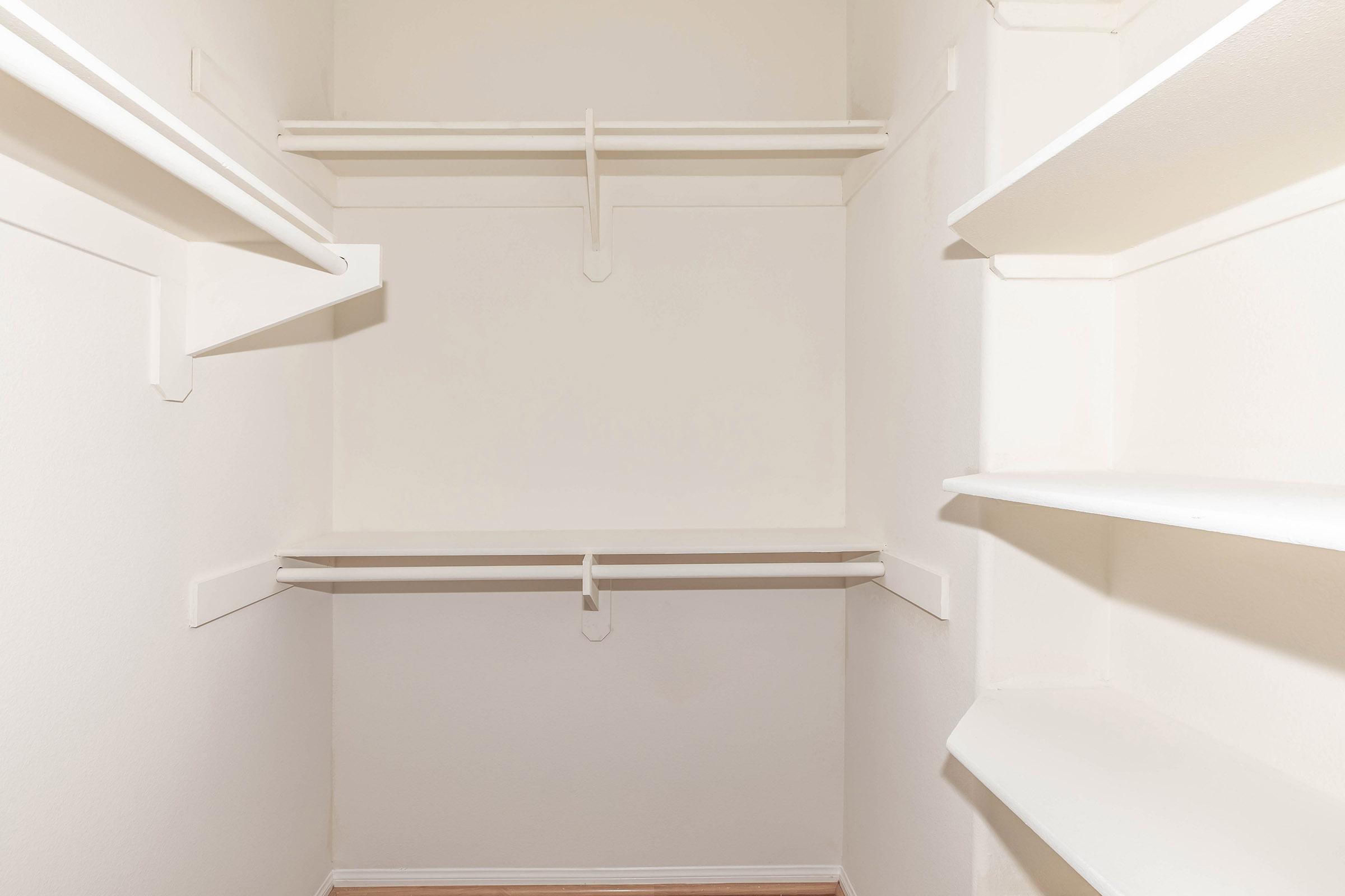 a walk-in closet with shelves