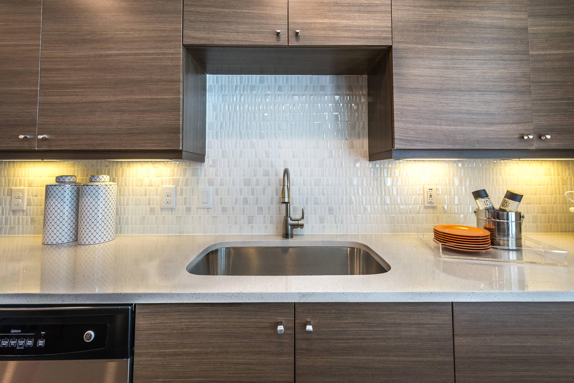 a kitchen with stainless steel appliances and wooden cabinets