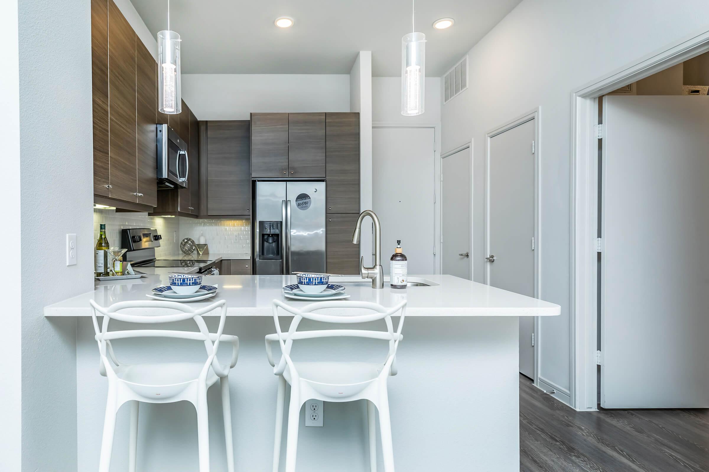 a kitchen with a sink and a mirror