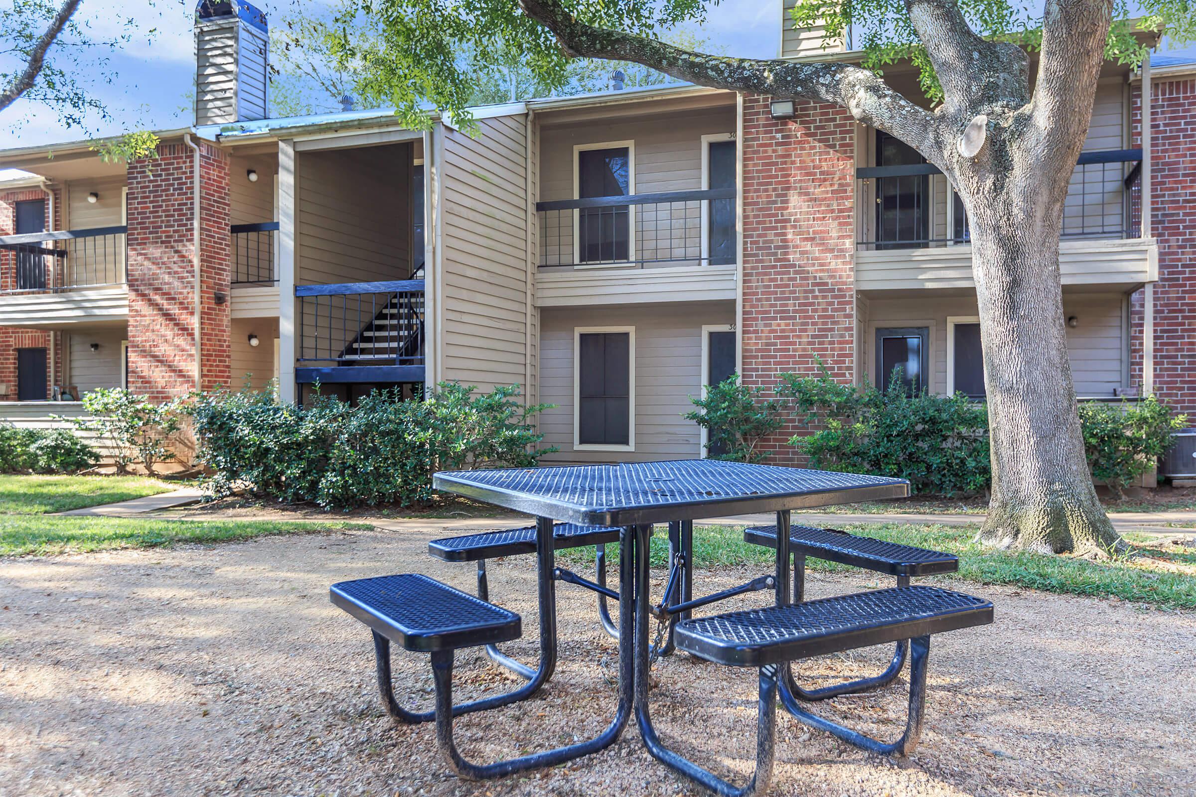 a couple of lawn chairs sitting on a bench in front of a building