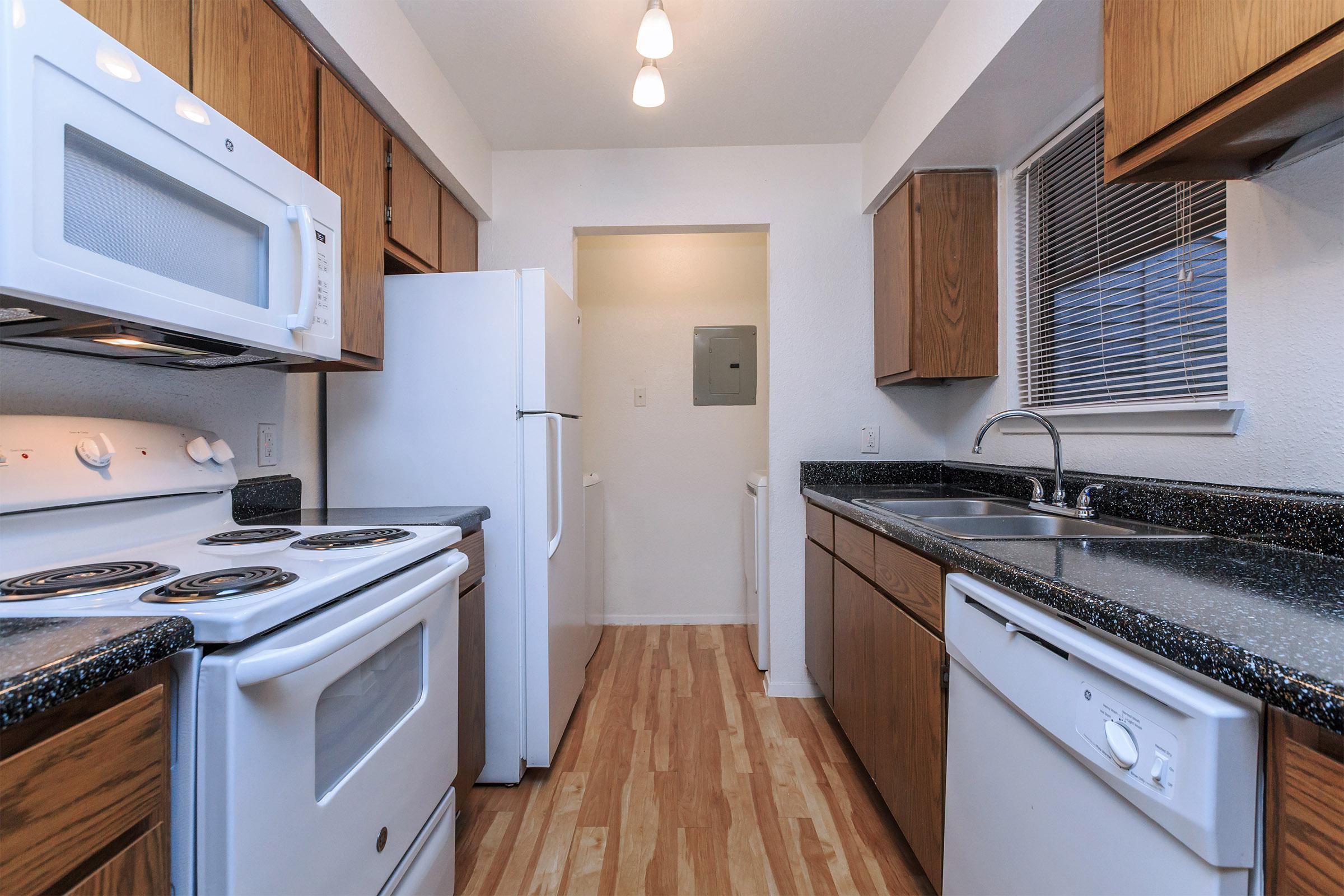 a white stove top oven sitting inside of a kitchen