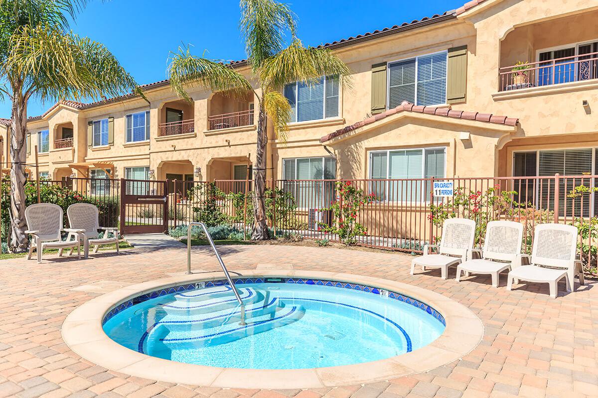 a pool in front of a brick building