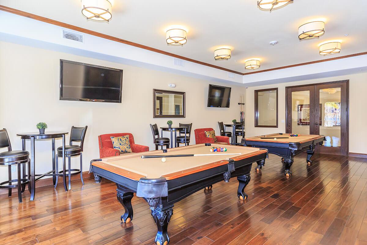 a living room filled with furniture and a wood floor