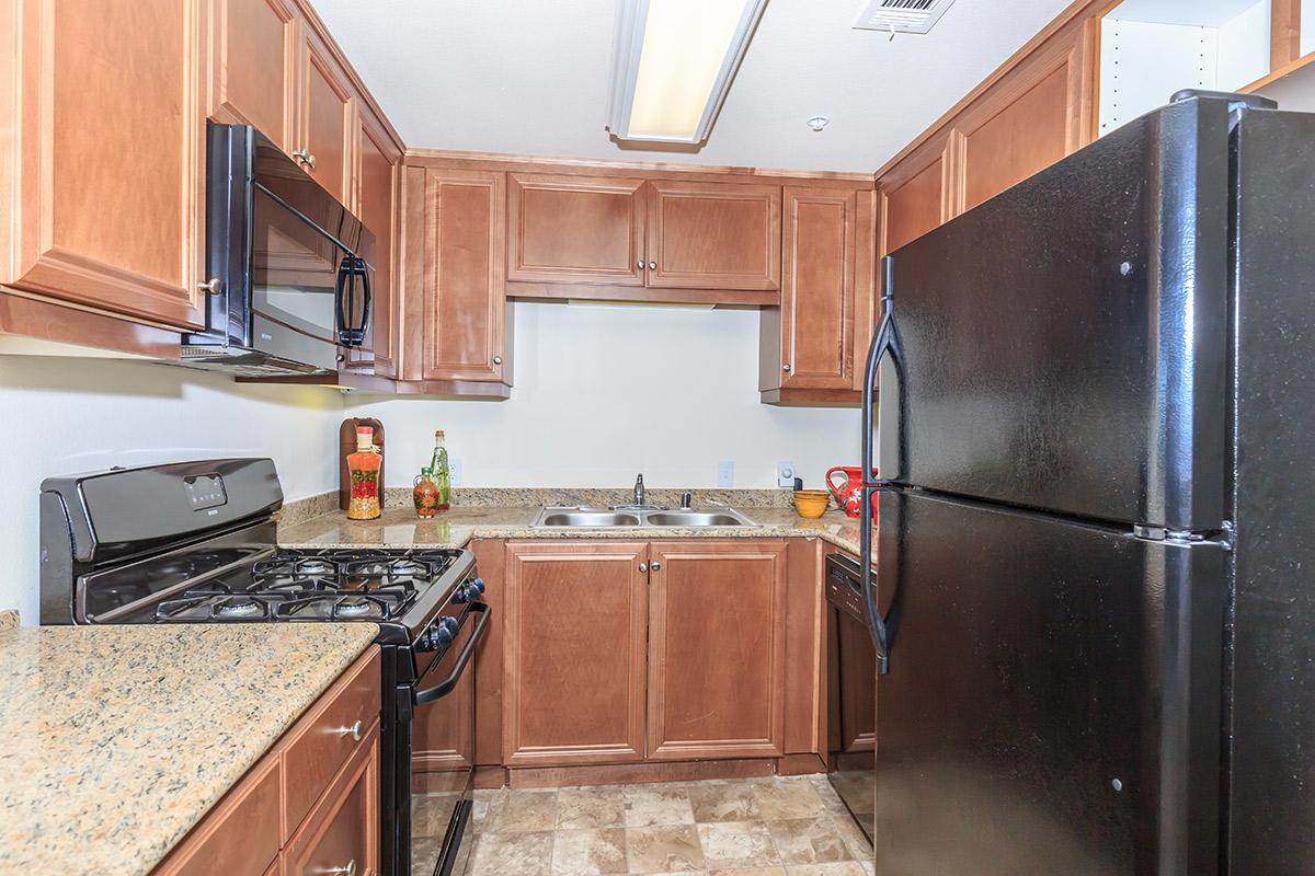 a kitchen with stainless steel appliances and wooden cabinets