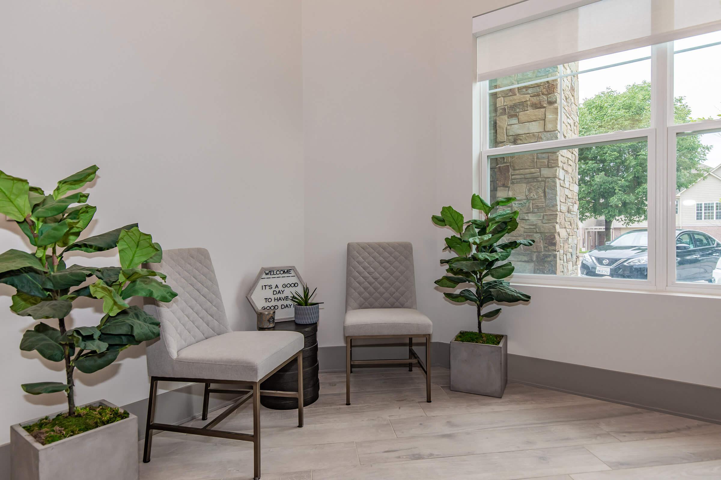 a living room filled with furniture and a large window