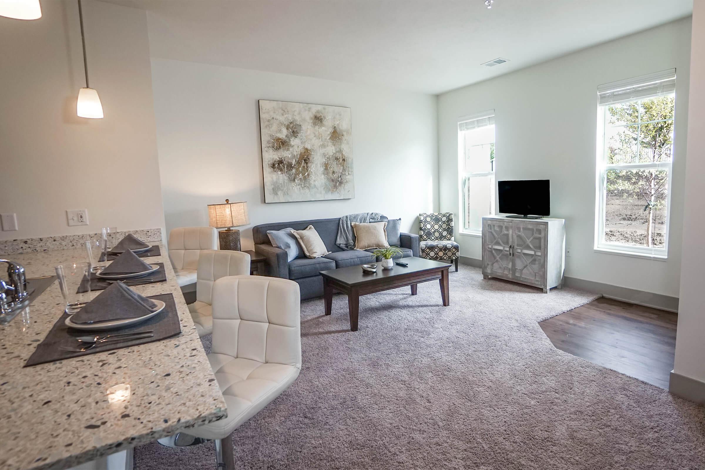 a living room filled with furniture and a flat screen tv