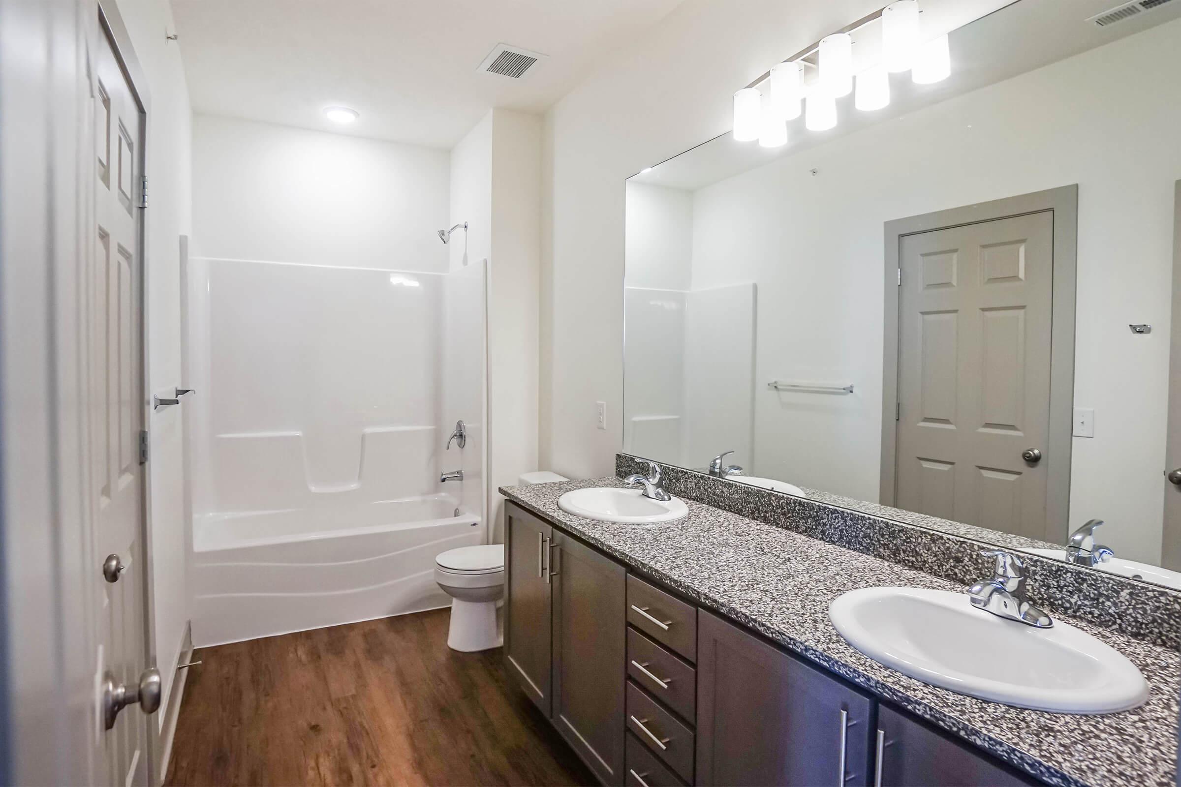 a kitchen with a sink and a mirror