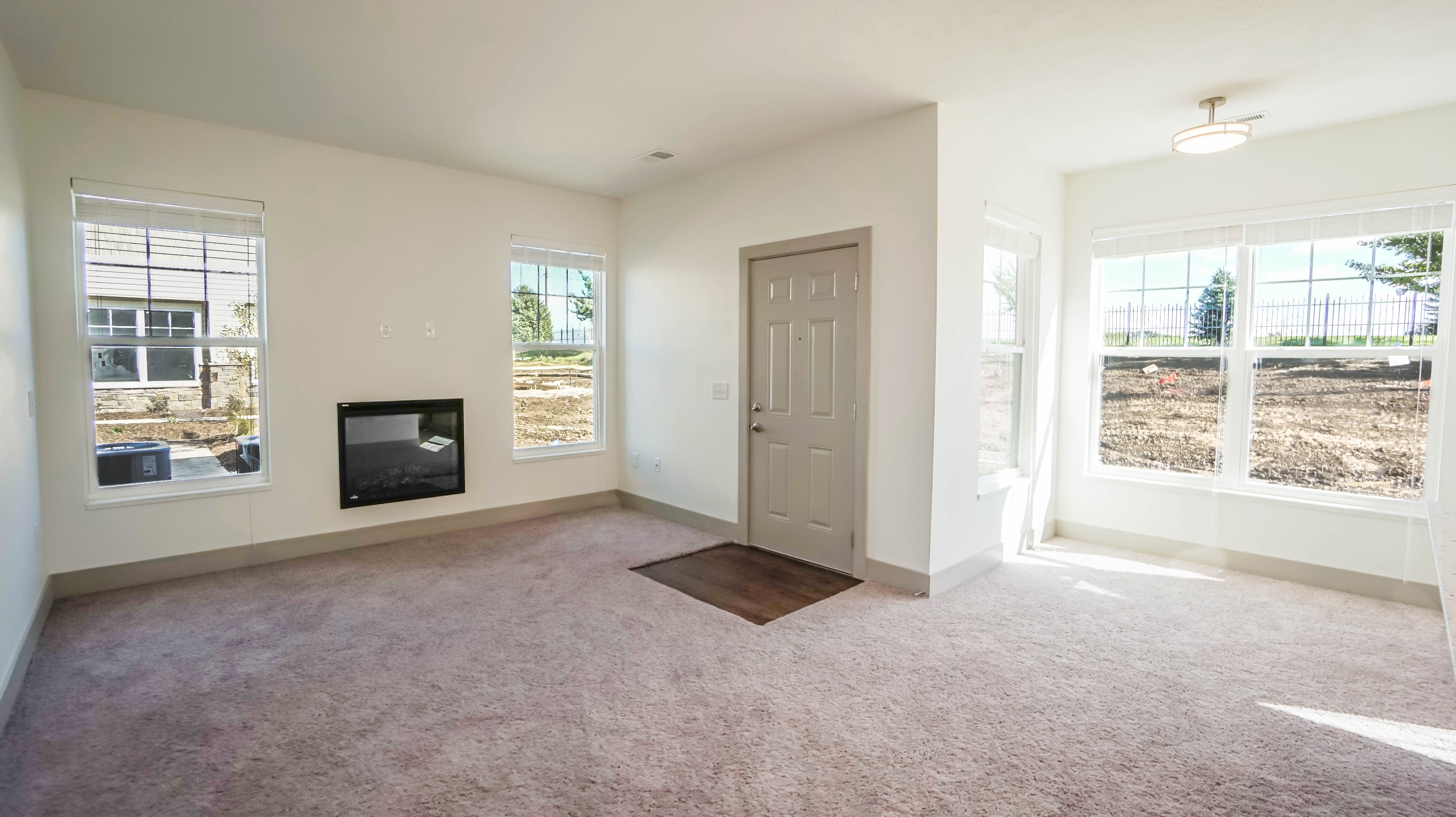 a living room filled with furniture and a large window
