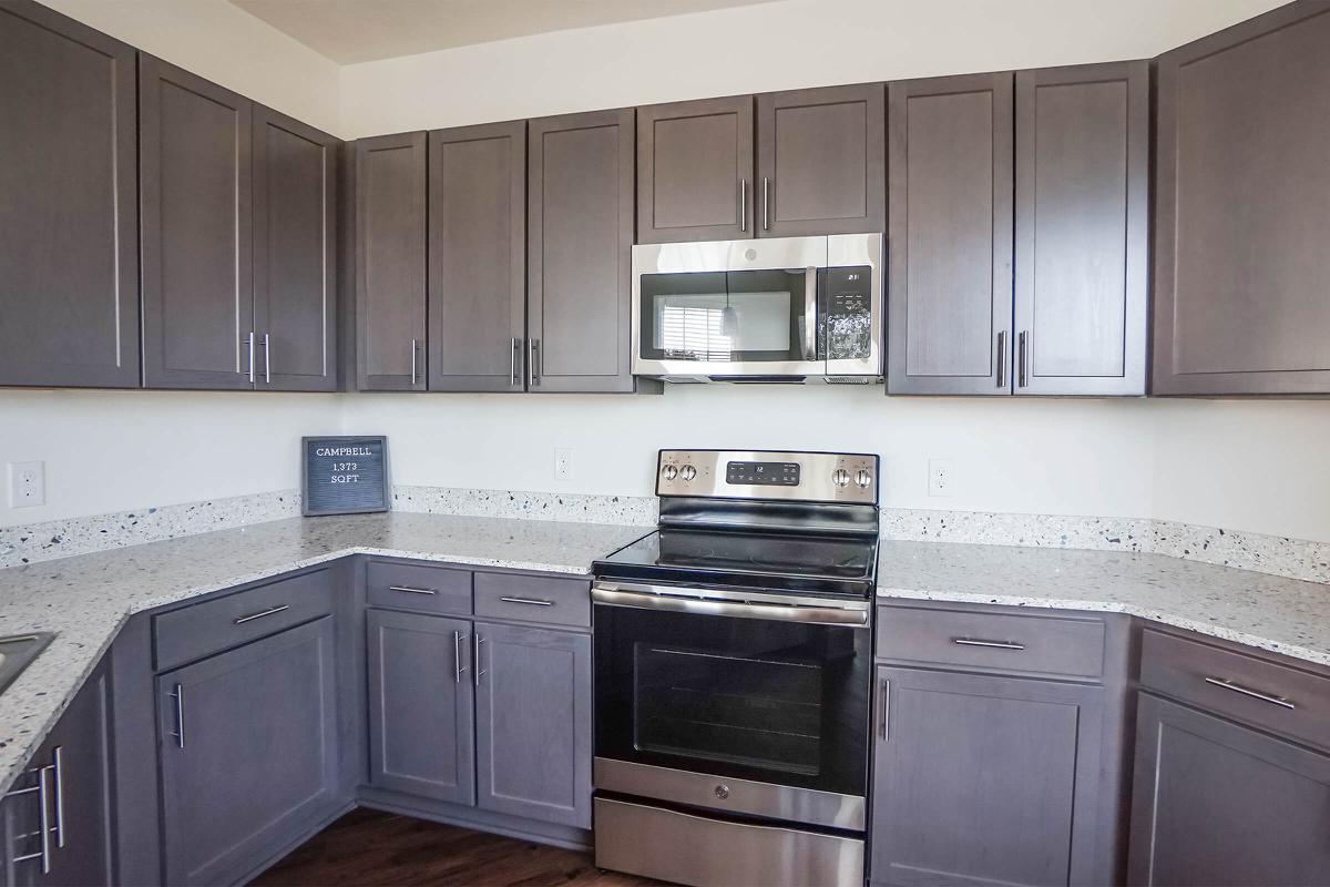 a kitchen with stainless steel appliances and wooden cabinets