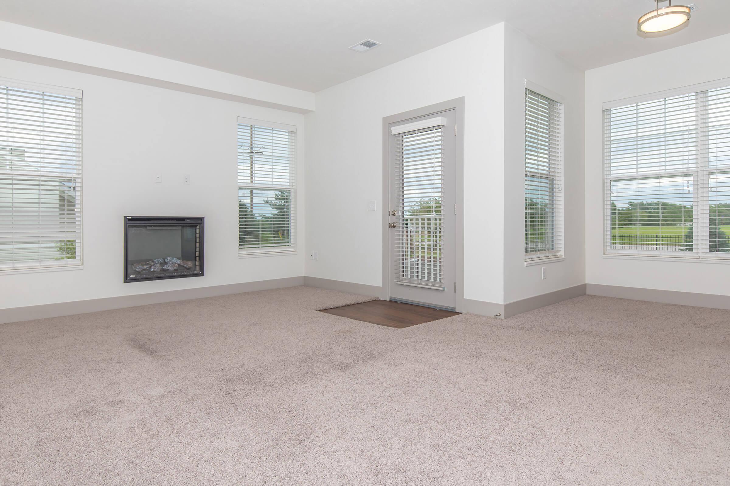 a living room filled with furniture and a large window