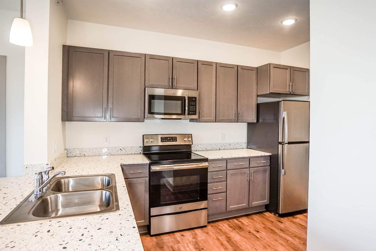 a kitchen with stainless steel appliances and wooden cabinets